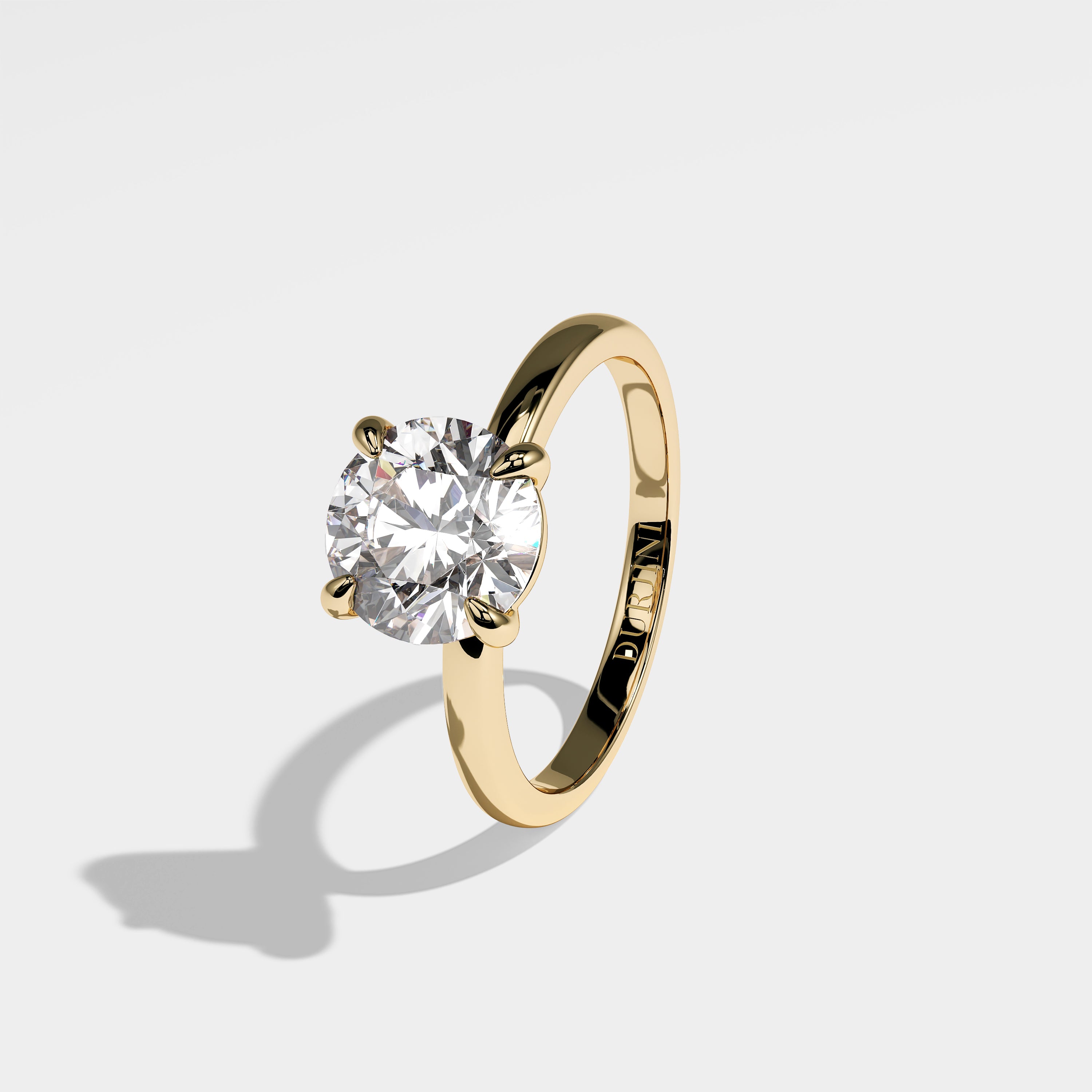 Granite round brilliant diamond engagement ring in 18K yellow gold by Kurbãni Durjini, left view