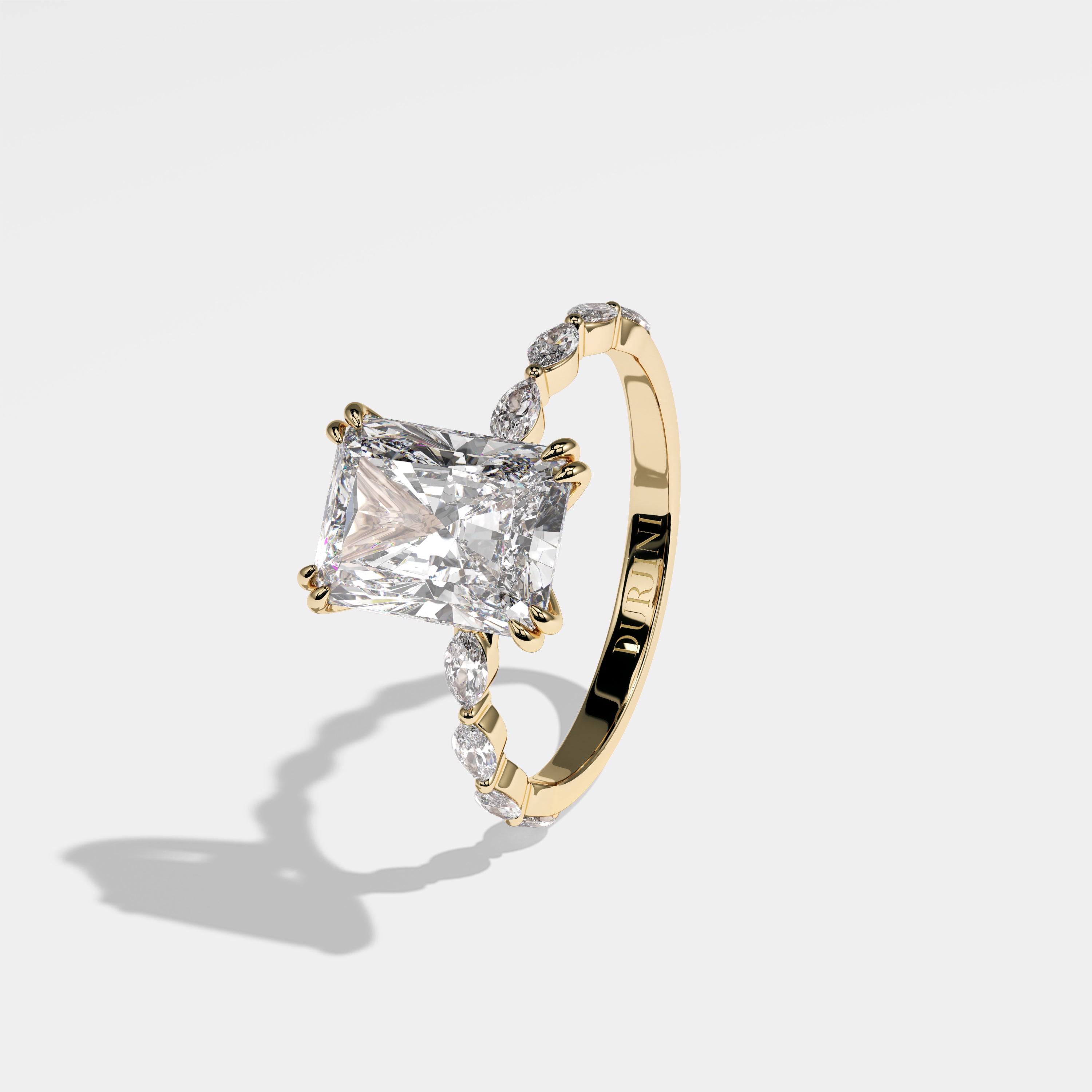 Castle radiant halo diamond engagement ring in 18K yellow gold by Kurbãni Durjini, left view