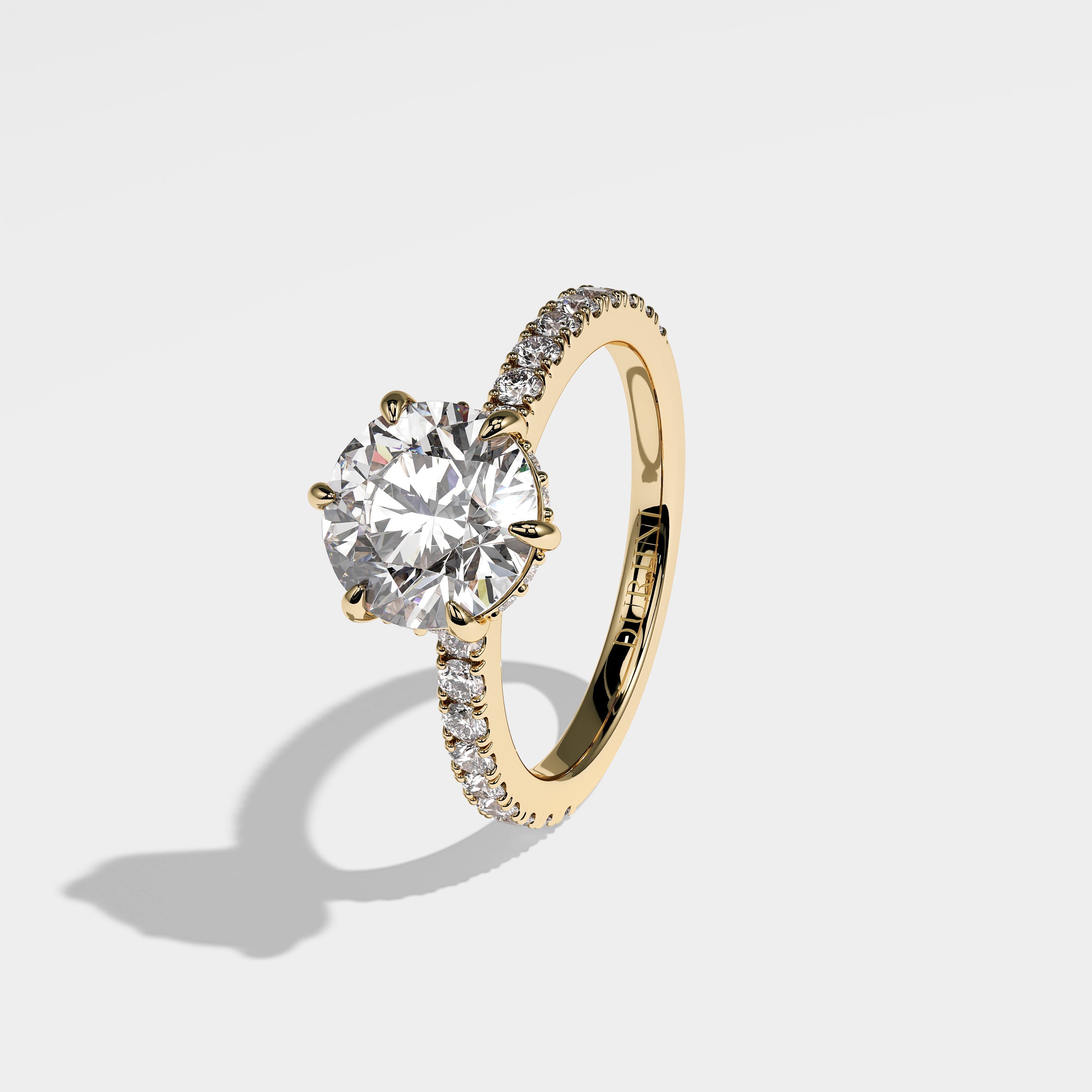 Starlight round brilliant halo diamond engagement ring in 18K yellow gold by Kurbãni Durjini, left view
