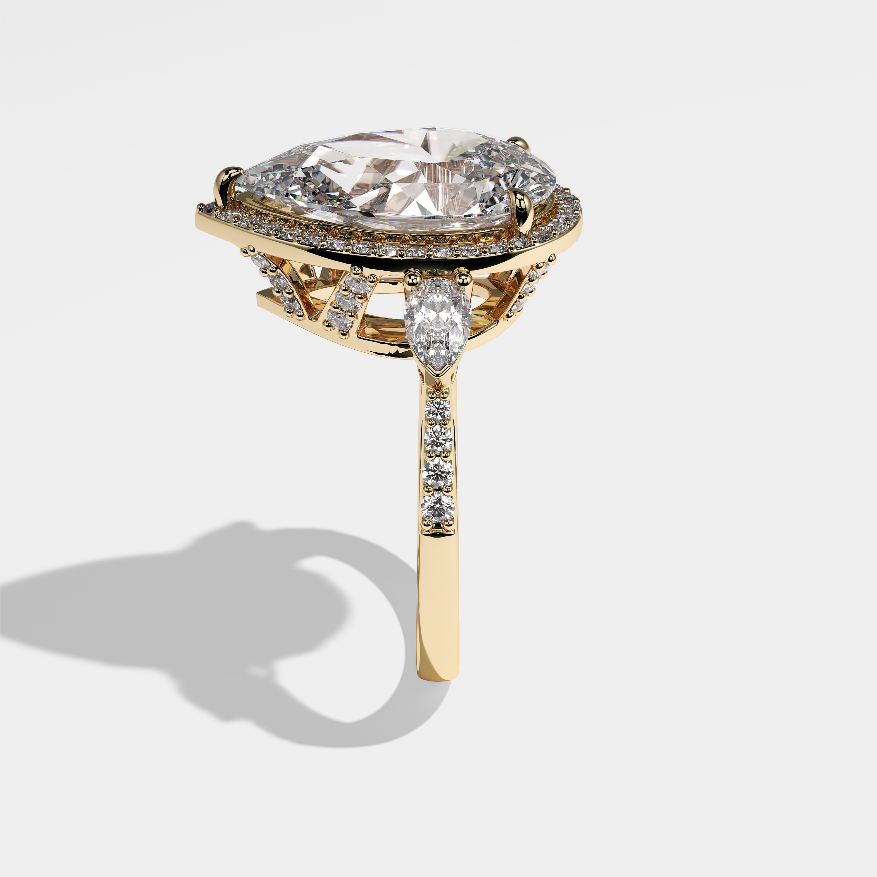 Sienna pear halo diamond engagement ring in 18K yellow gold by Kurbãni Durjini, side view
