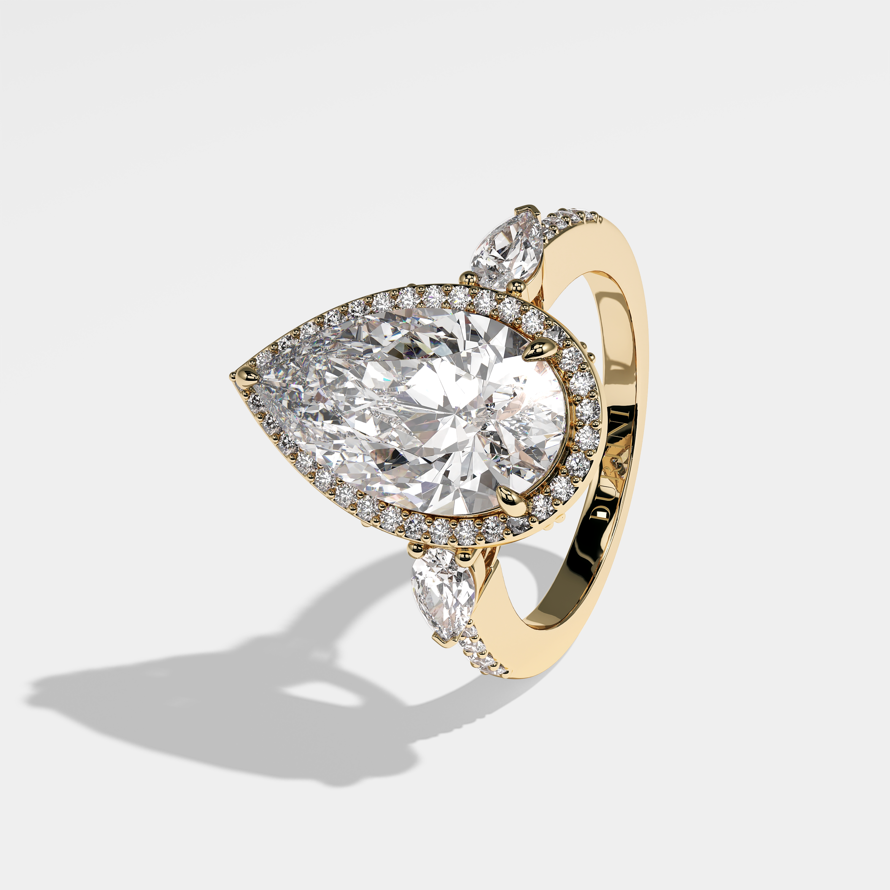 Sienna pear halo diamond engagement ring in 18K yellow gold by Kurbãni Durjini, left view