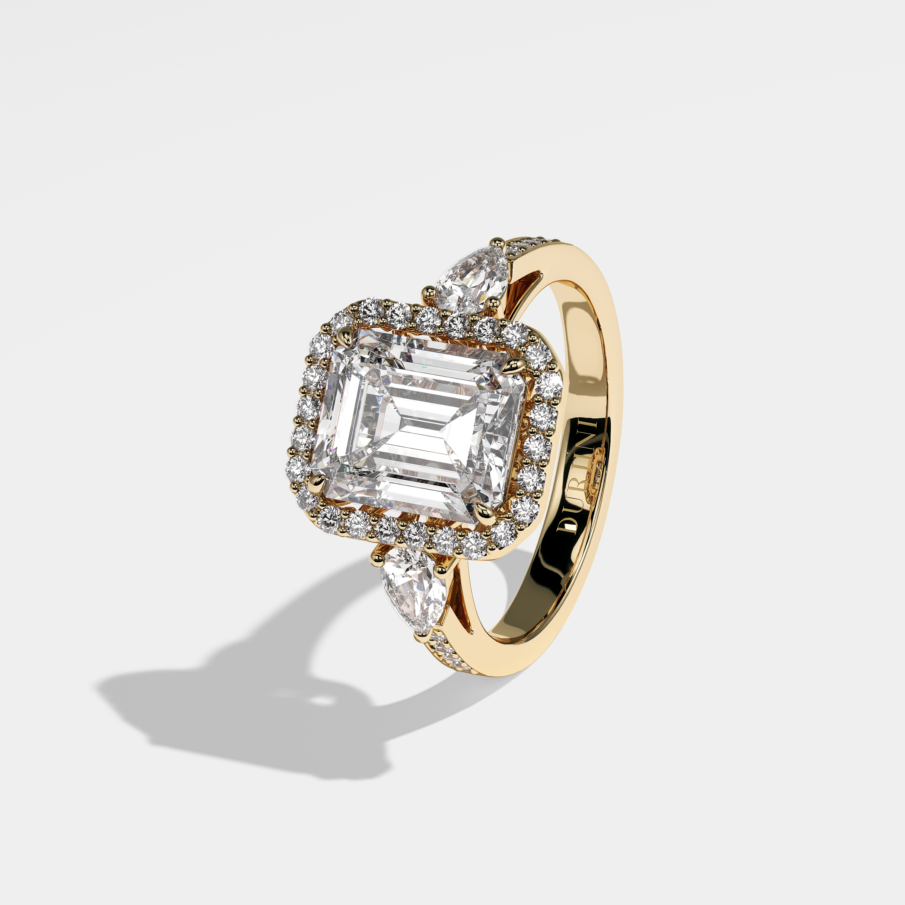Atlas emerald-cut diamond engagement ring in 18K yellow gold by Kurbãni Durjini, left view