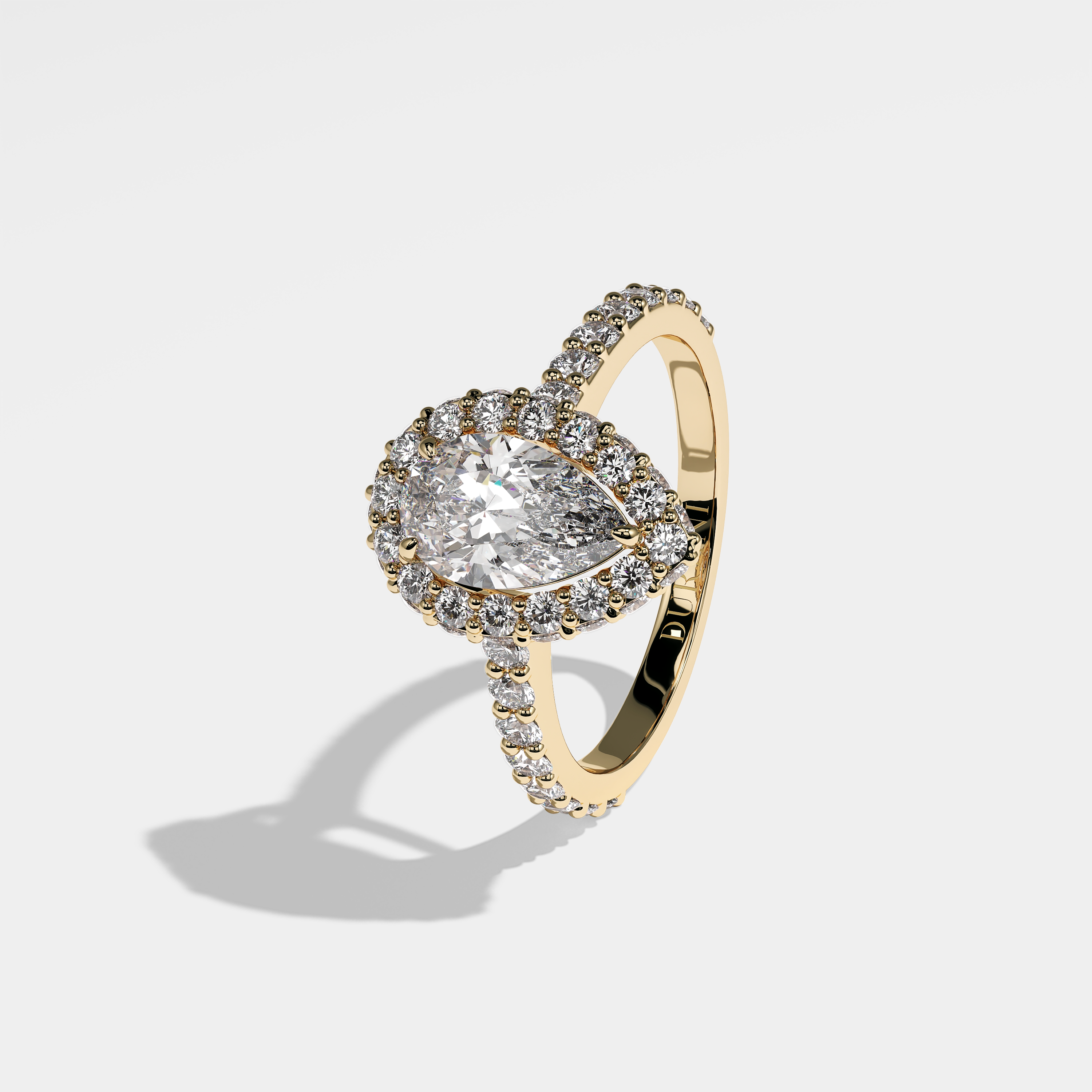 Cecilia pear halo diamond engagement ring in 18K yellow gold by Kurbãni Durjini, left view