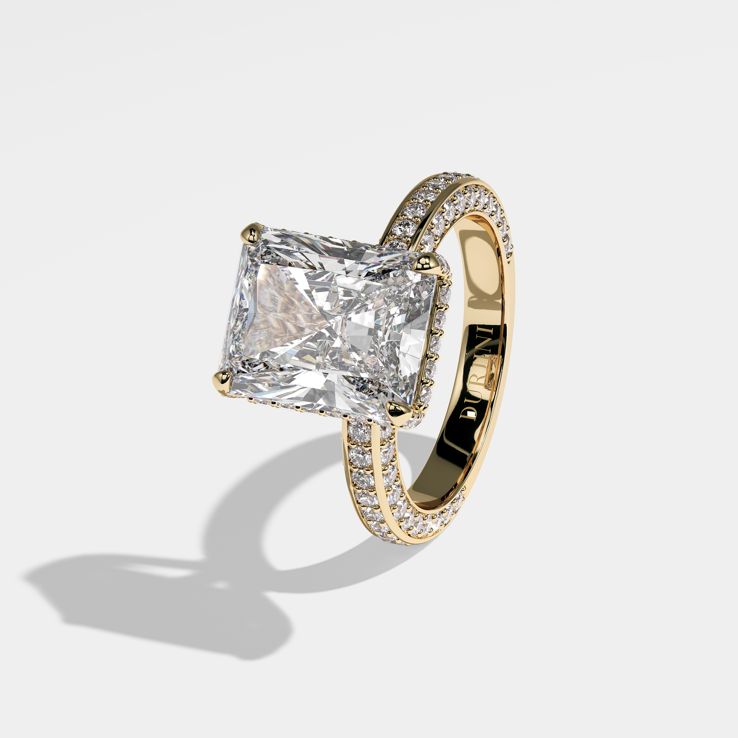Constance radiant halo diamond engagement ring in 18K yellow gold by Kurbãni Durjini, left view