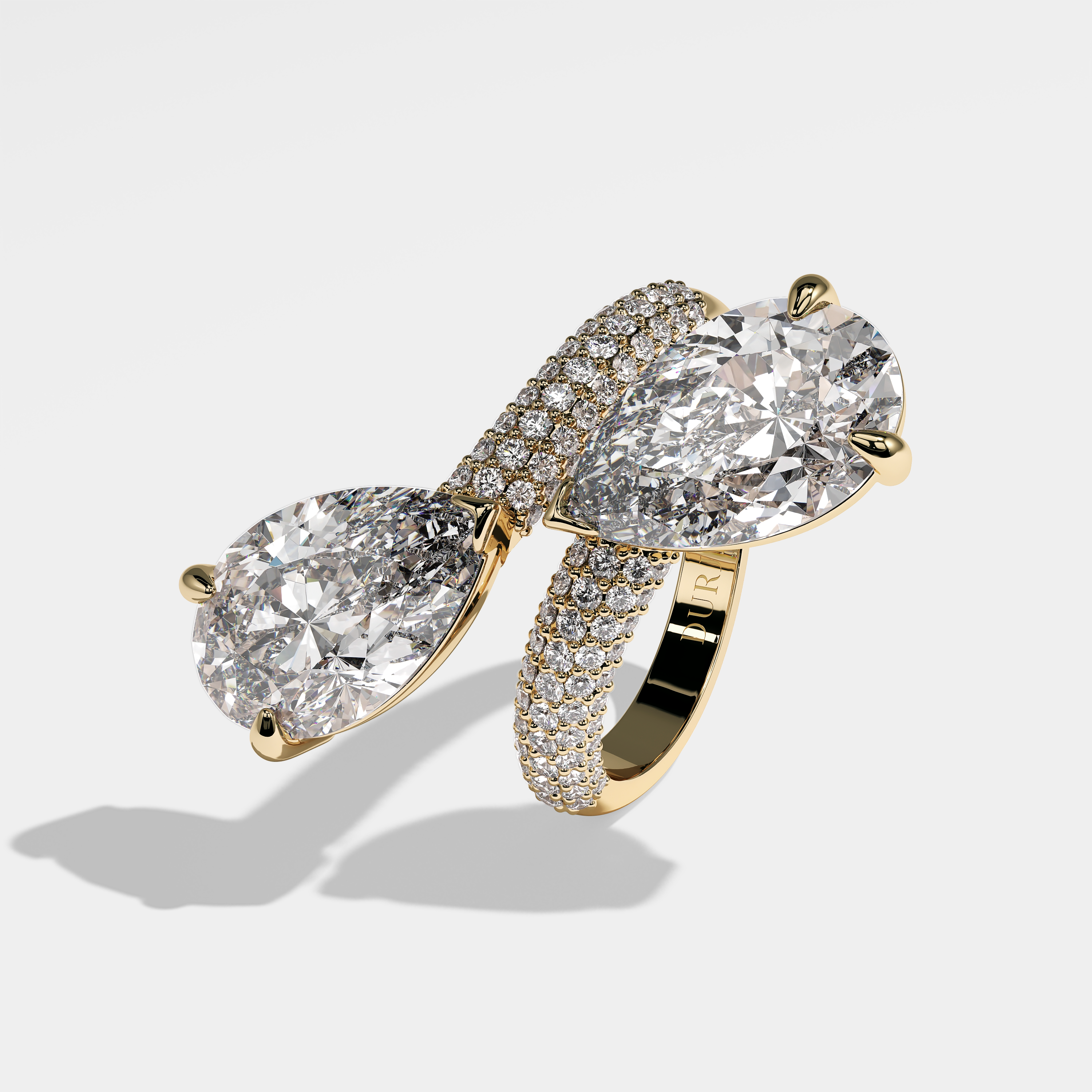 Millicent pear diamond engagement ring in 18K yellow gold by Kurbãni Durjini, left view