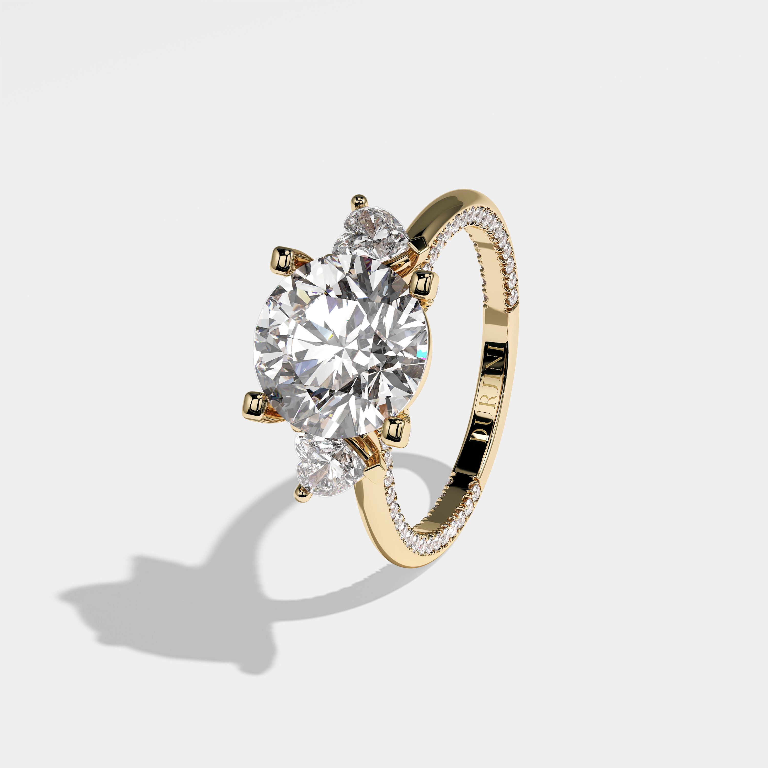Mariana round brilliant diamond engagement ring in 18K yellow gold by Kurbãni Durjini, left view