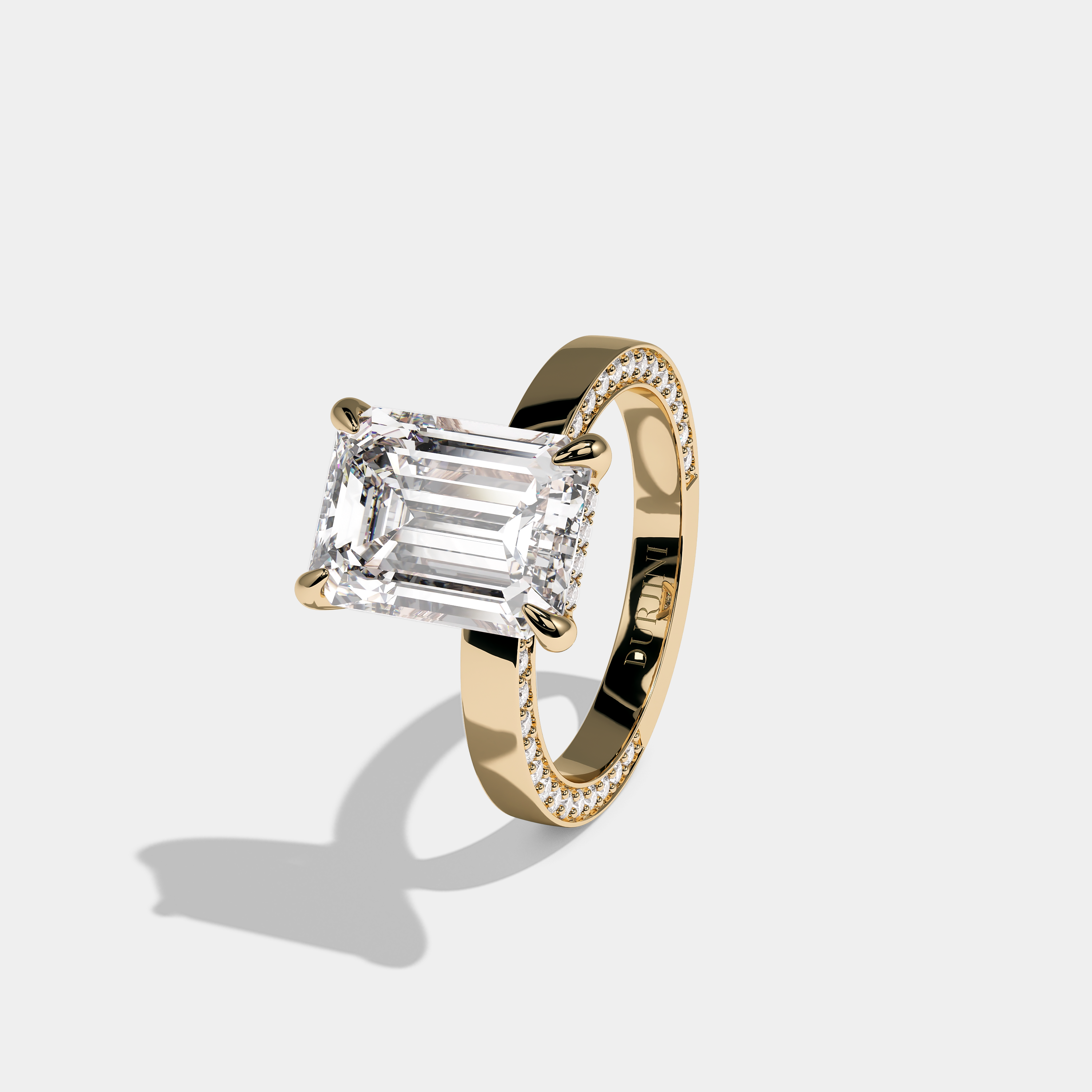 Left View – Kurbãni Durjini Brilliance Diamond Emerald Cut Engagement Ring Yellow Gold