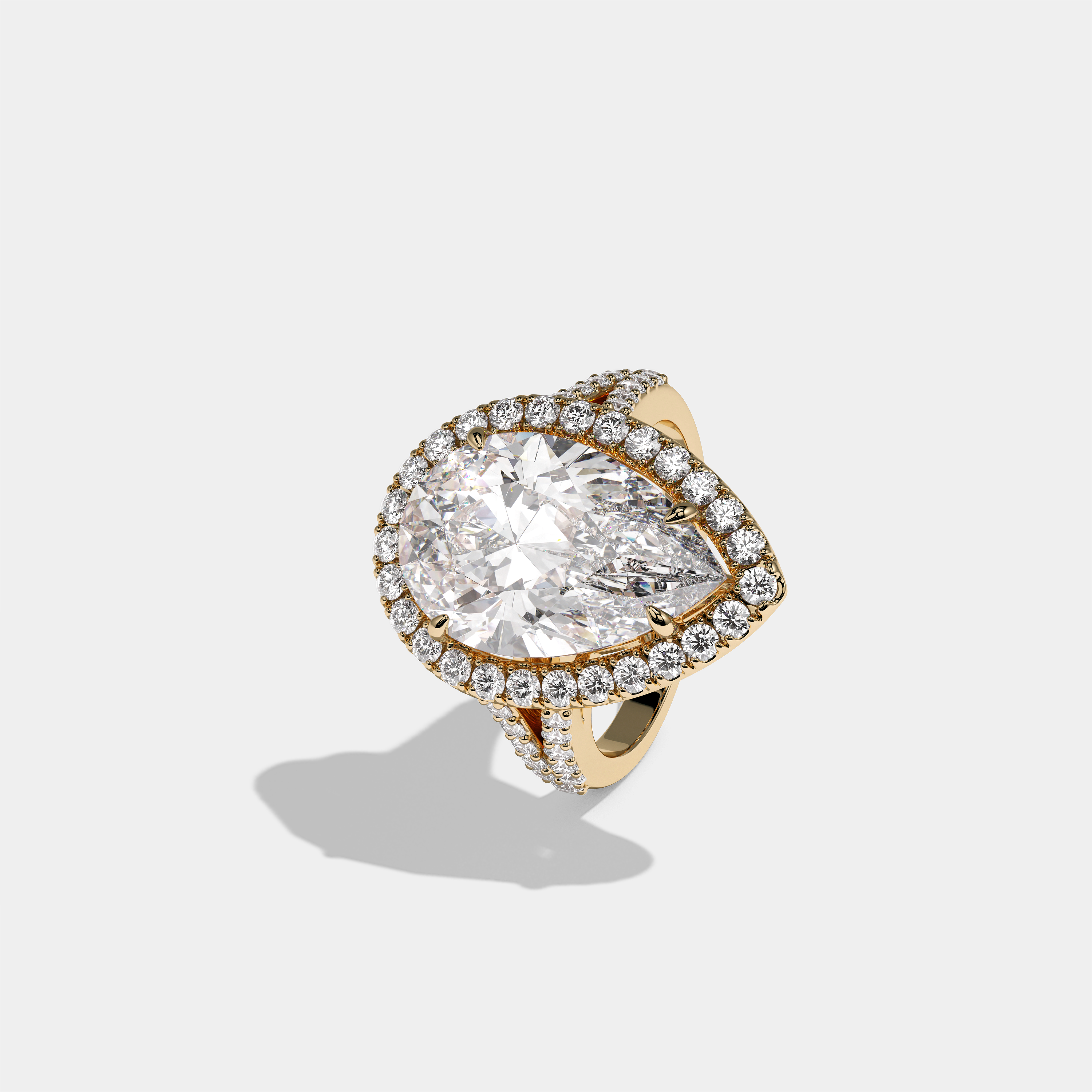 Helena Viscountess diamond pear halo engagement ring in 18K yellow gold by Kurbãni Durjini, left view