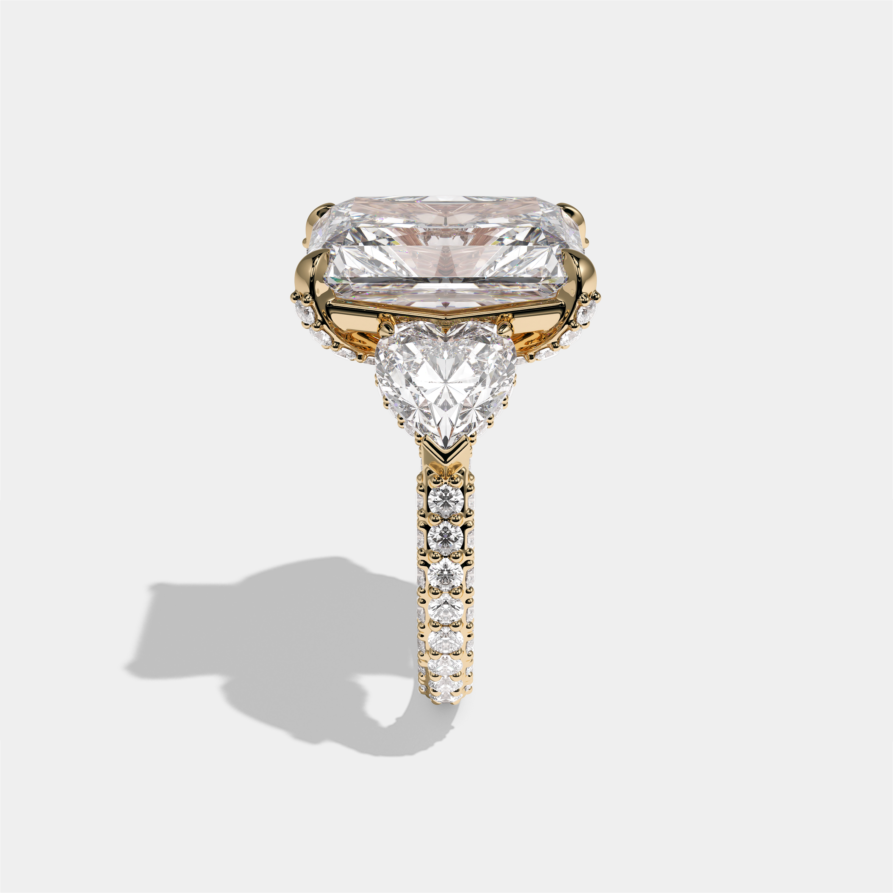 Chaya Lady Ravenscroft diamond radiant halo engagement ring in 18K yellow gold by Kurbãni Durjini, side view