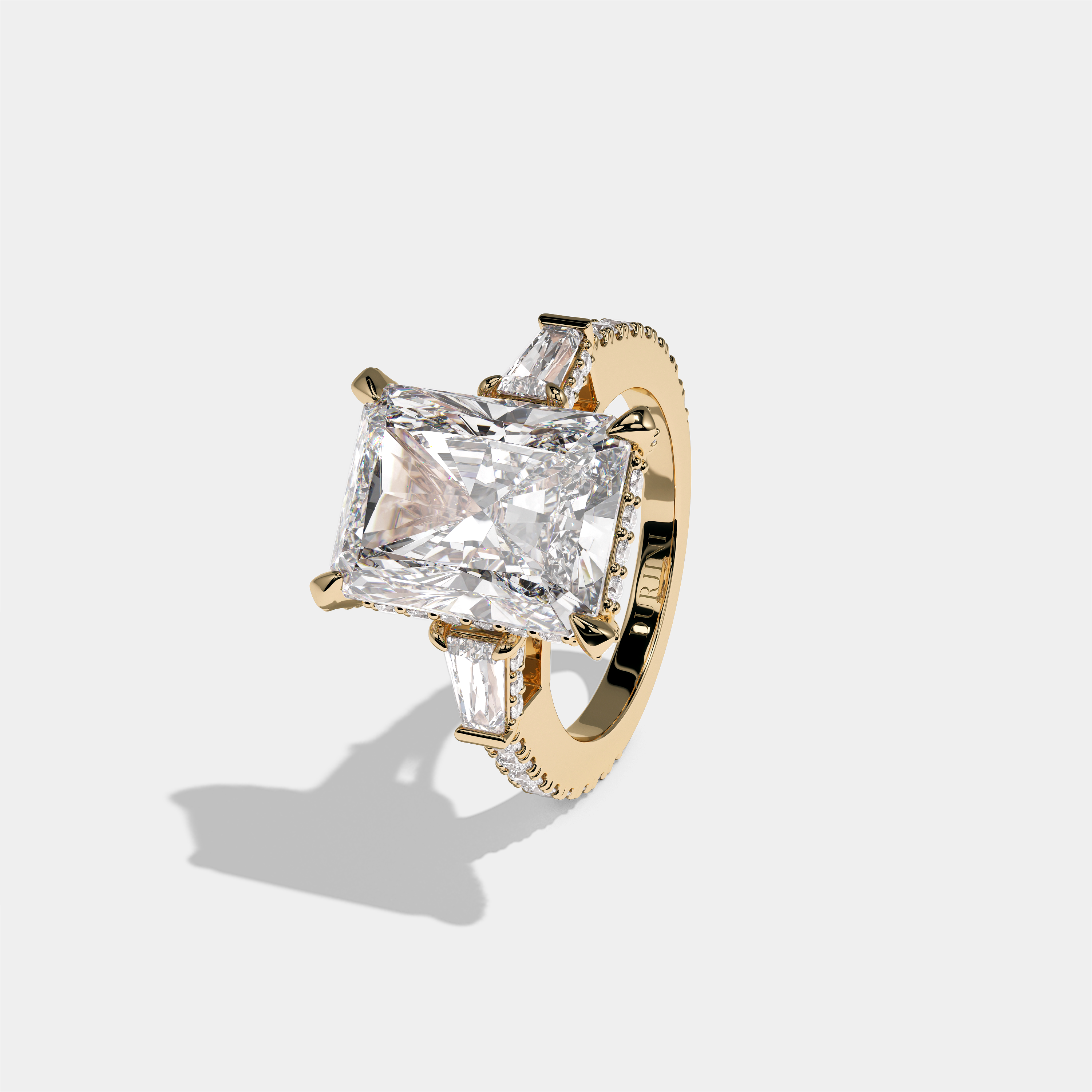 Esther Eclat Kingswood diamond radiant halo engagement ring in 18K yellow gold by Kurbãni Durjini, left view