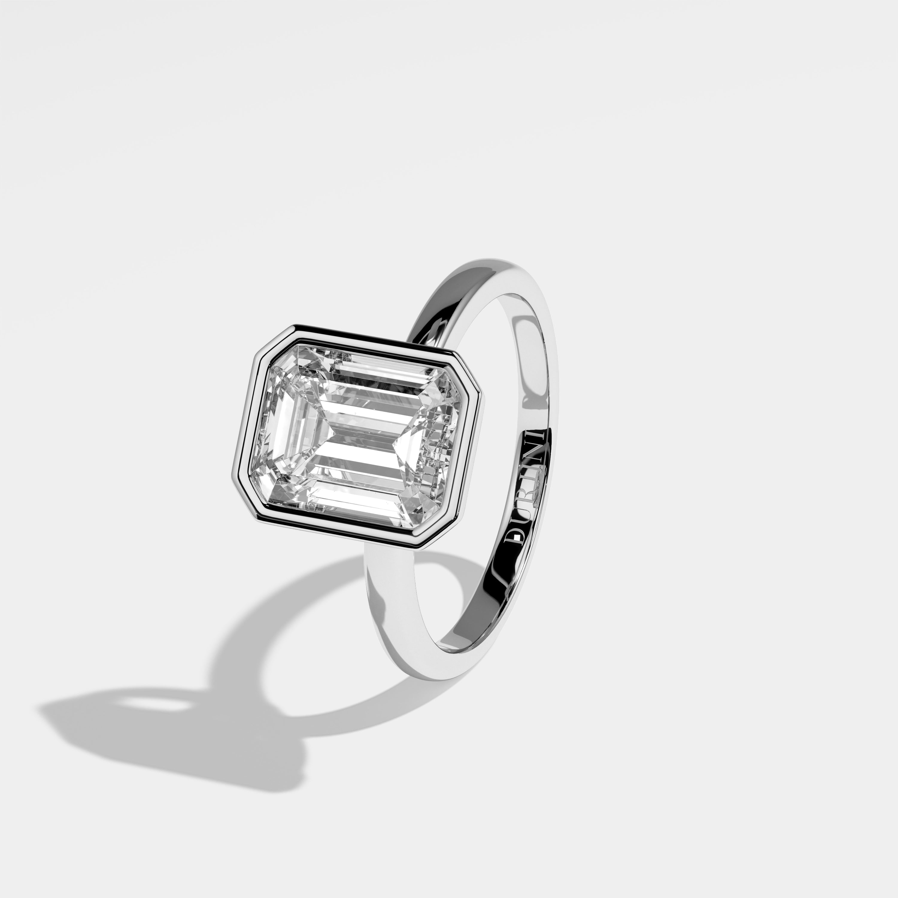 Pope emerald-cut diamond engagement ring in 18K white gold by Kurbãni Durjini, left view