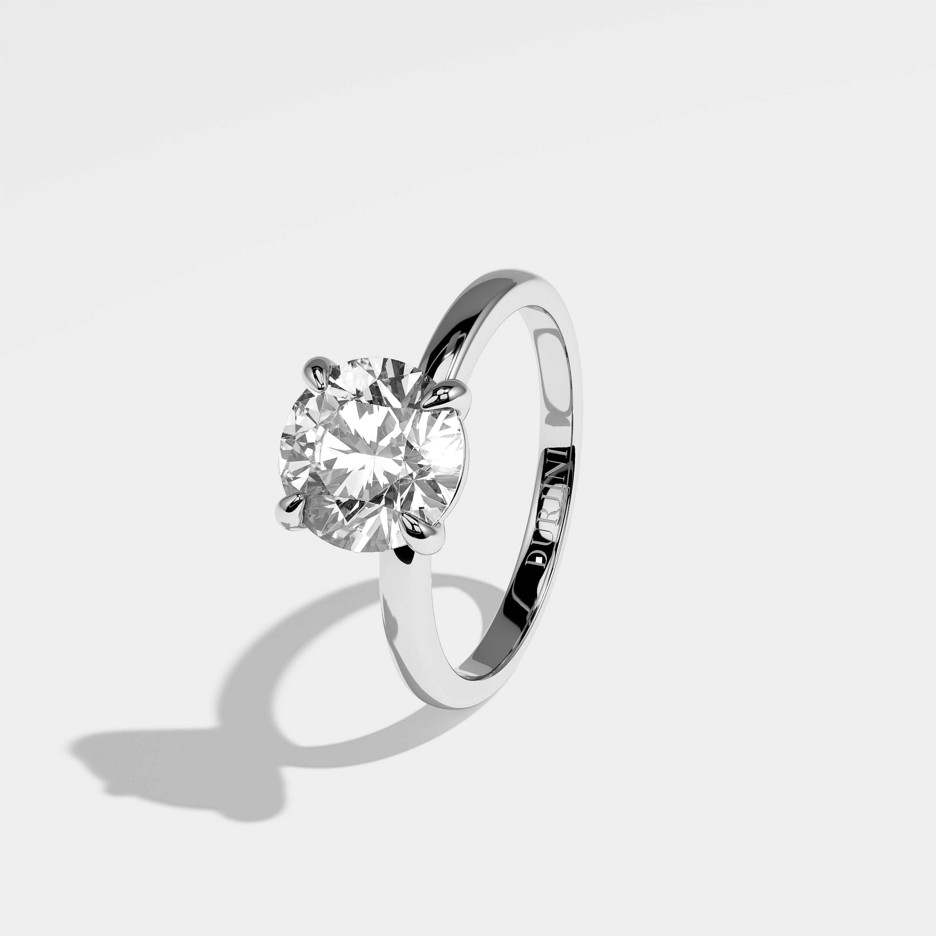 Stone round brilliant diamond engagement ring in 18K white gold by Kurbãni Durjini, left view