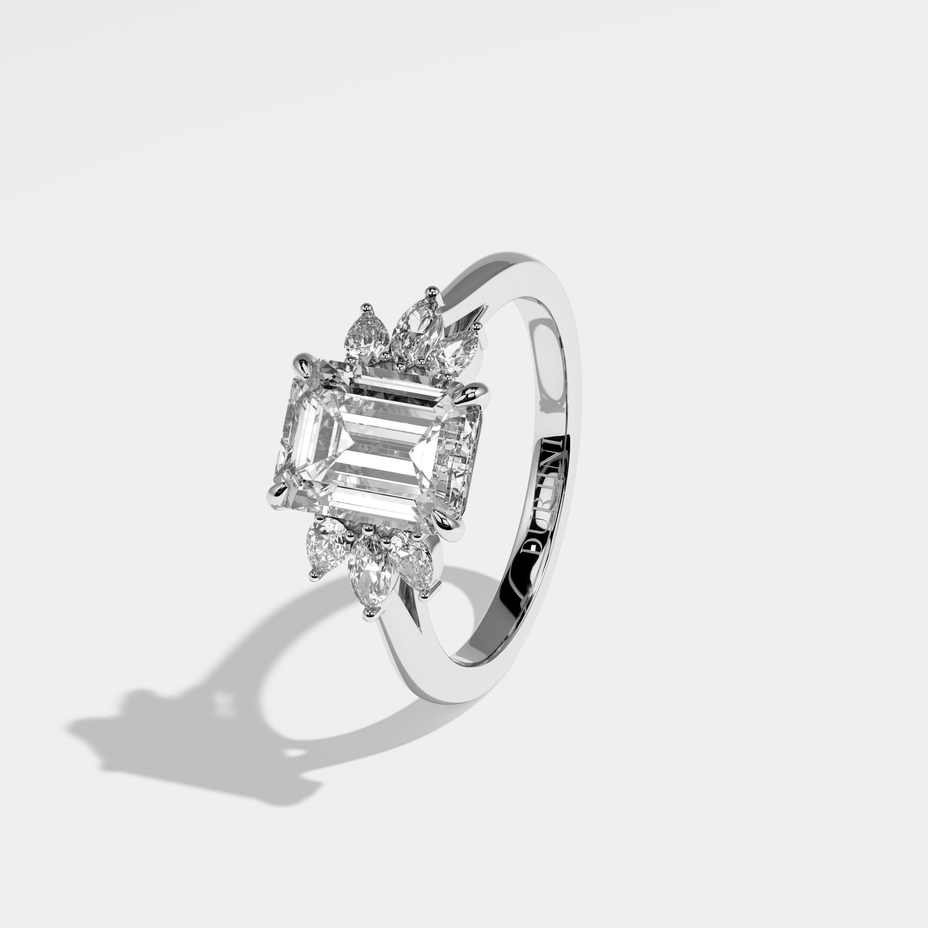 Mane emerald-cut diamond engagement ring in 18K white gold by Kurbãni Durjini, left view