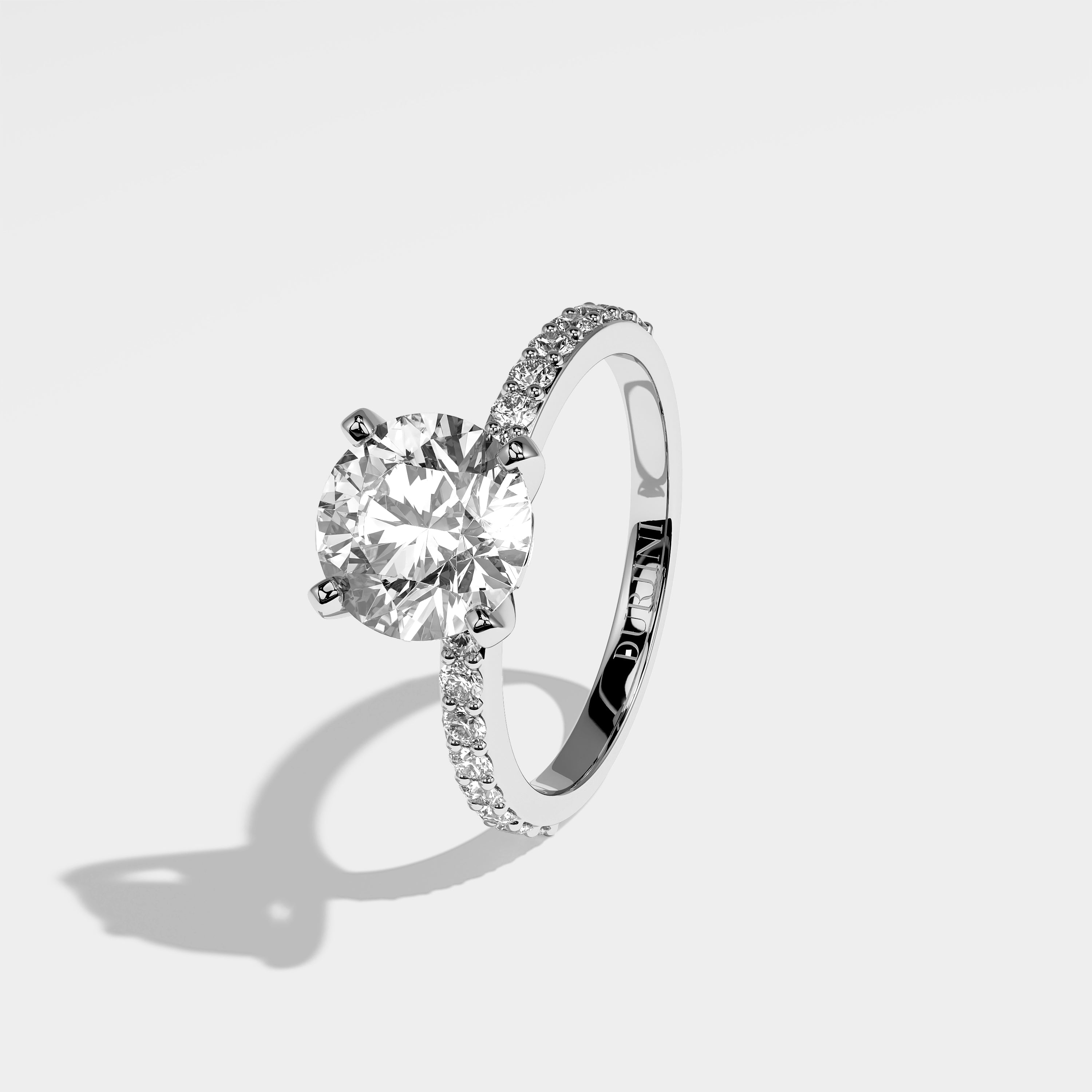Shard round brilliant diamond engagement ring in 18K white gold by Kurbãni Durjini, left view