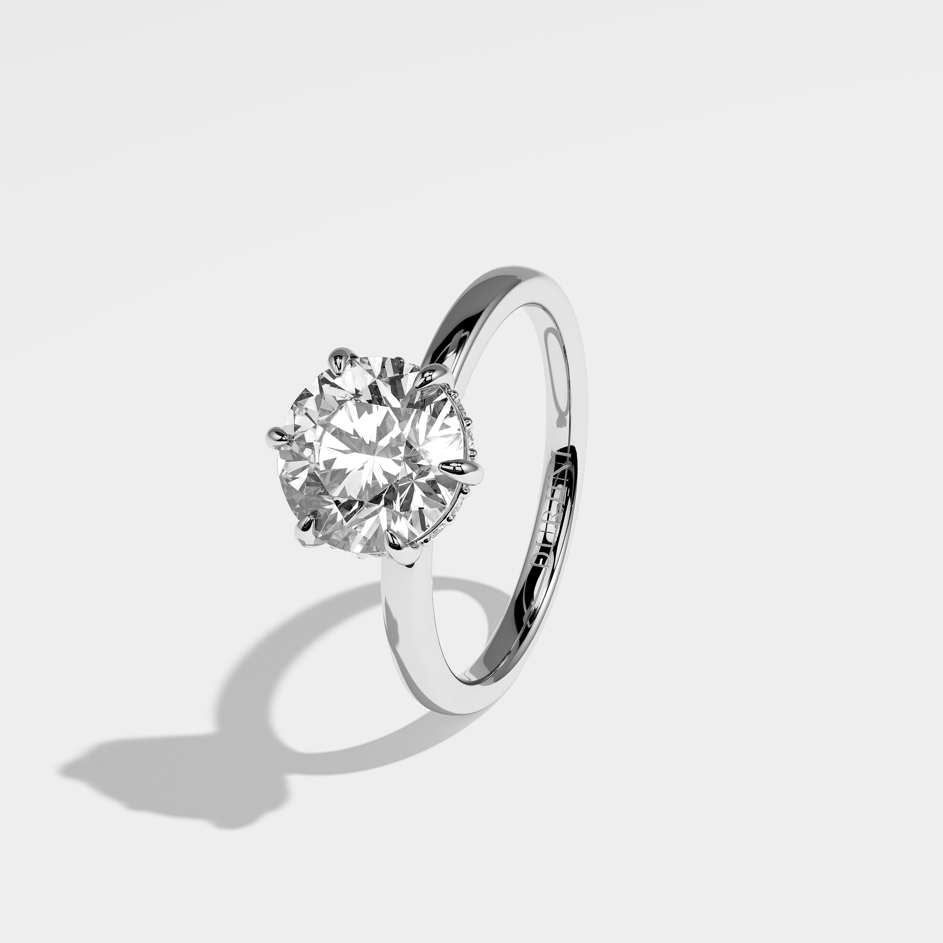 Dinesty round brilliant diamond engagement ring in 18K white gold by Kurbãni Durjini, left view