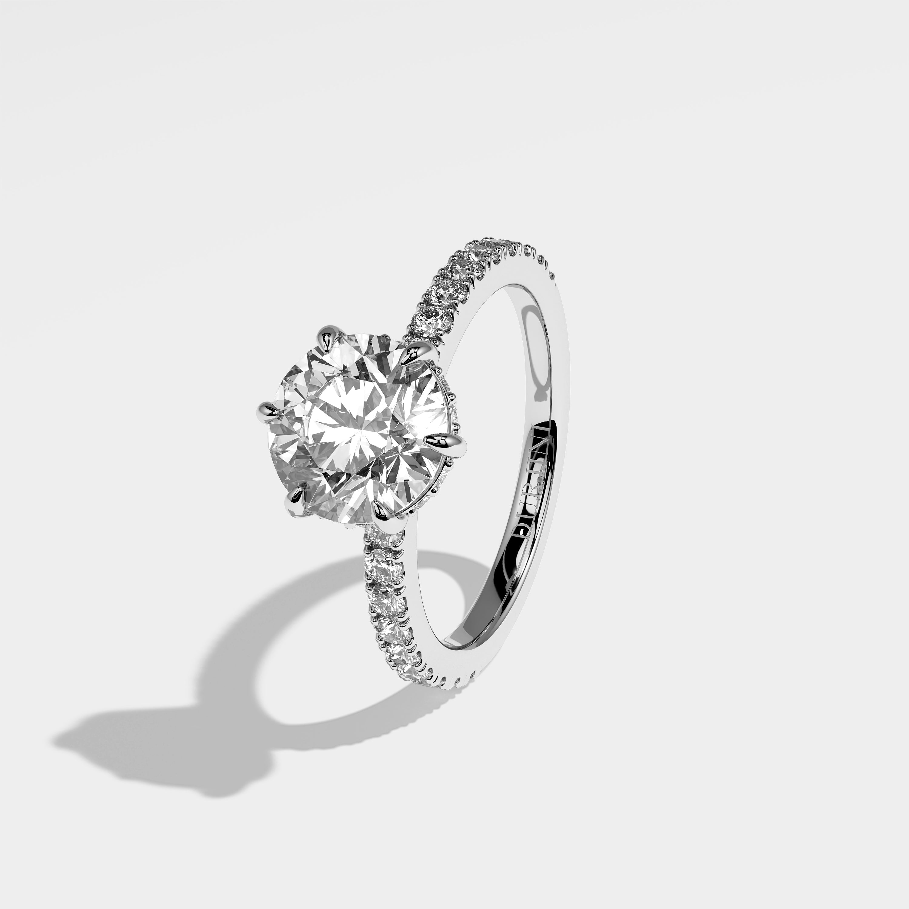 Moon round brilliant halo diamond engagement ring in 18K white gold by Kurbãni Durjini, left view