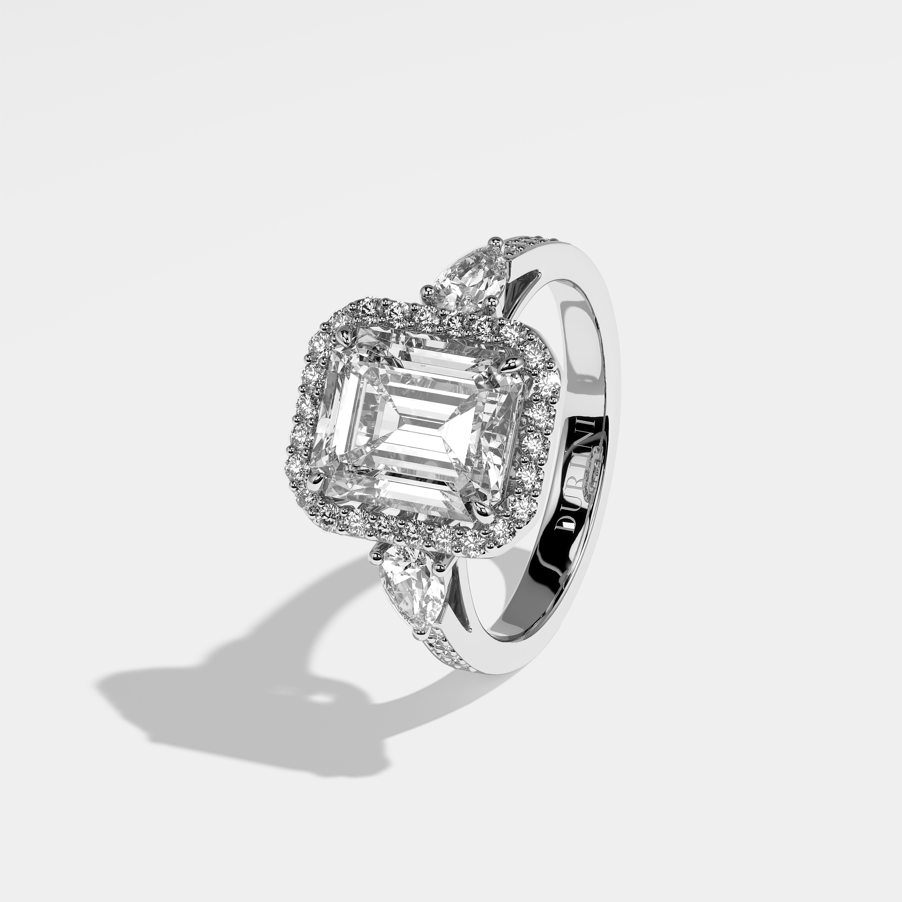Olly emerald halo diamond engagement ring in 18K white gold by Kurbãni Durjini, left view