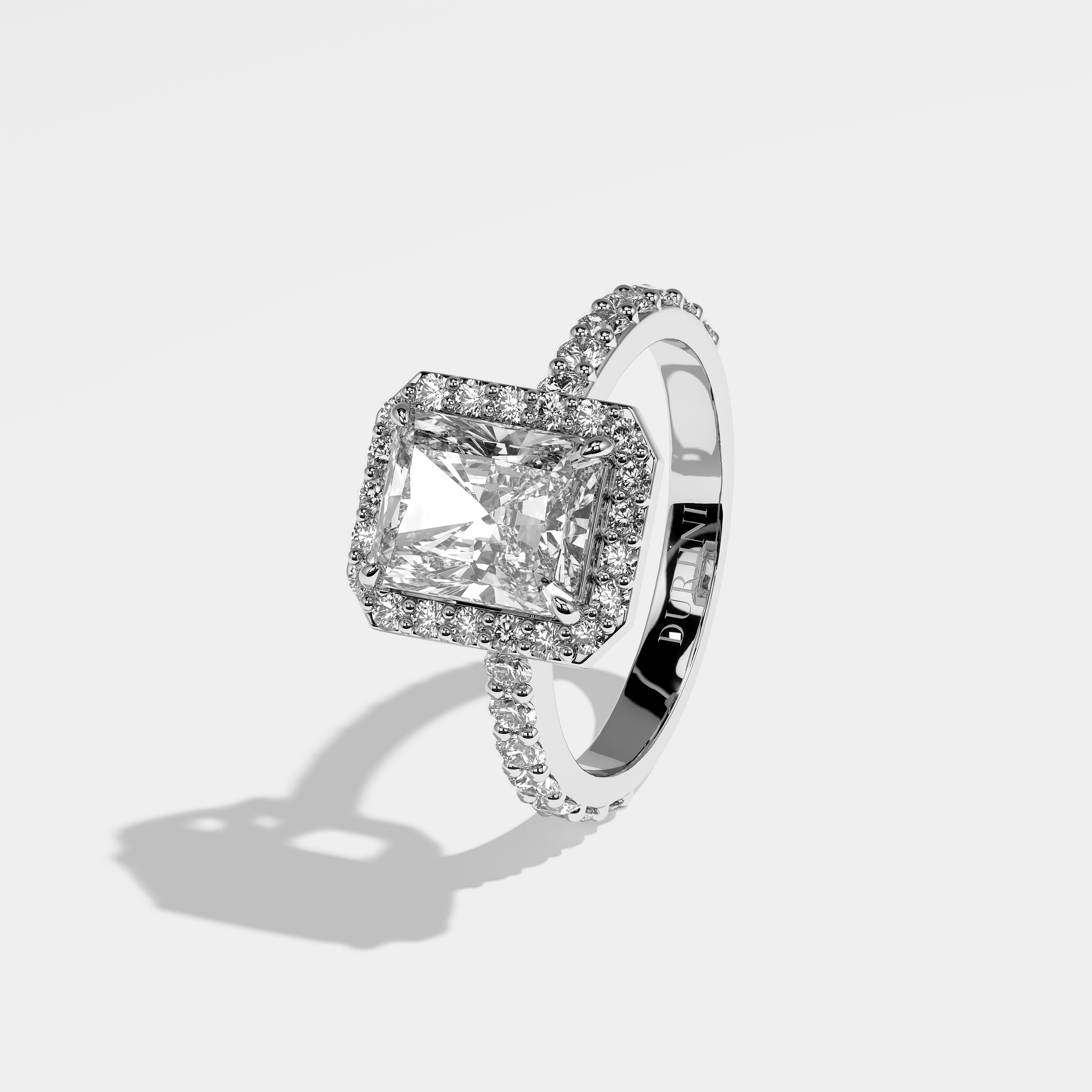 Nicola halo diamond engagement ring in 18K white gold by Kurbãni Durjini, left view