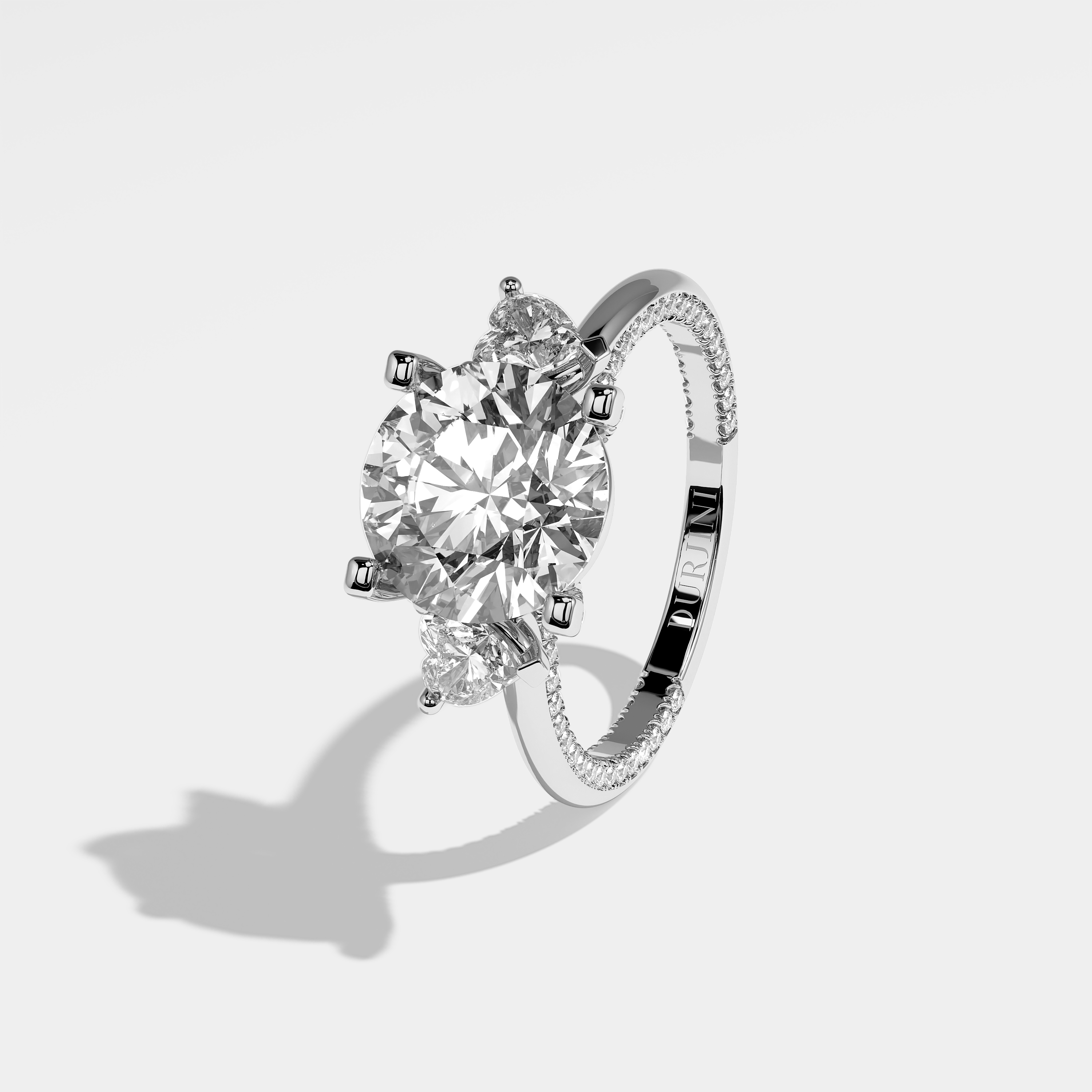 Amara round brilliant diamond engagement ring in 18K white gold by Kurbãni Durjini, left view