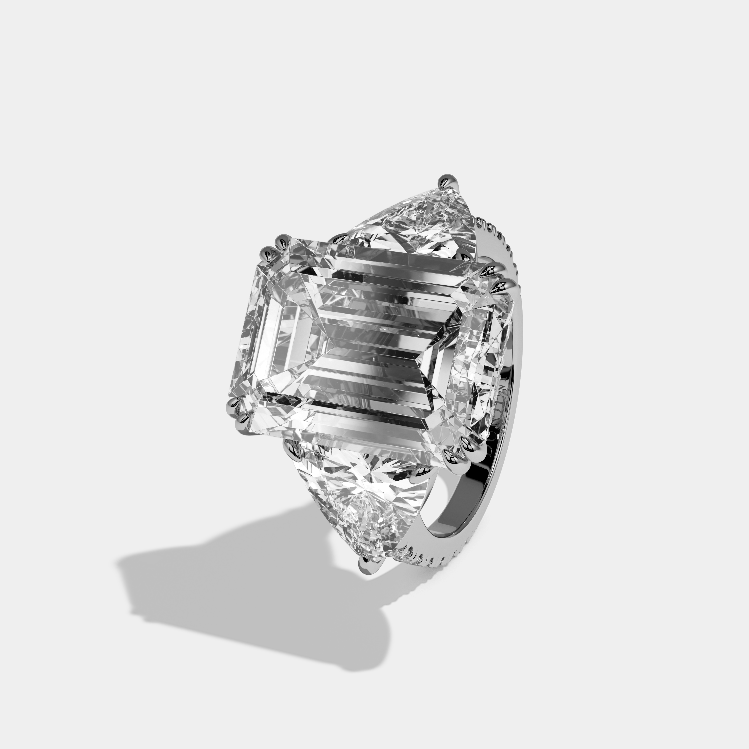 Vionnet Emerald Cut Diamond Halo Engagement Ring With Twin Trillion Cut Sides 10ct 18k White Gold
