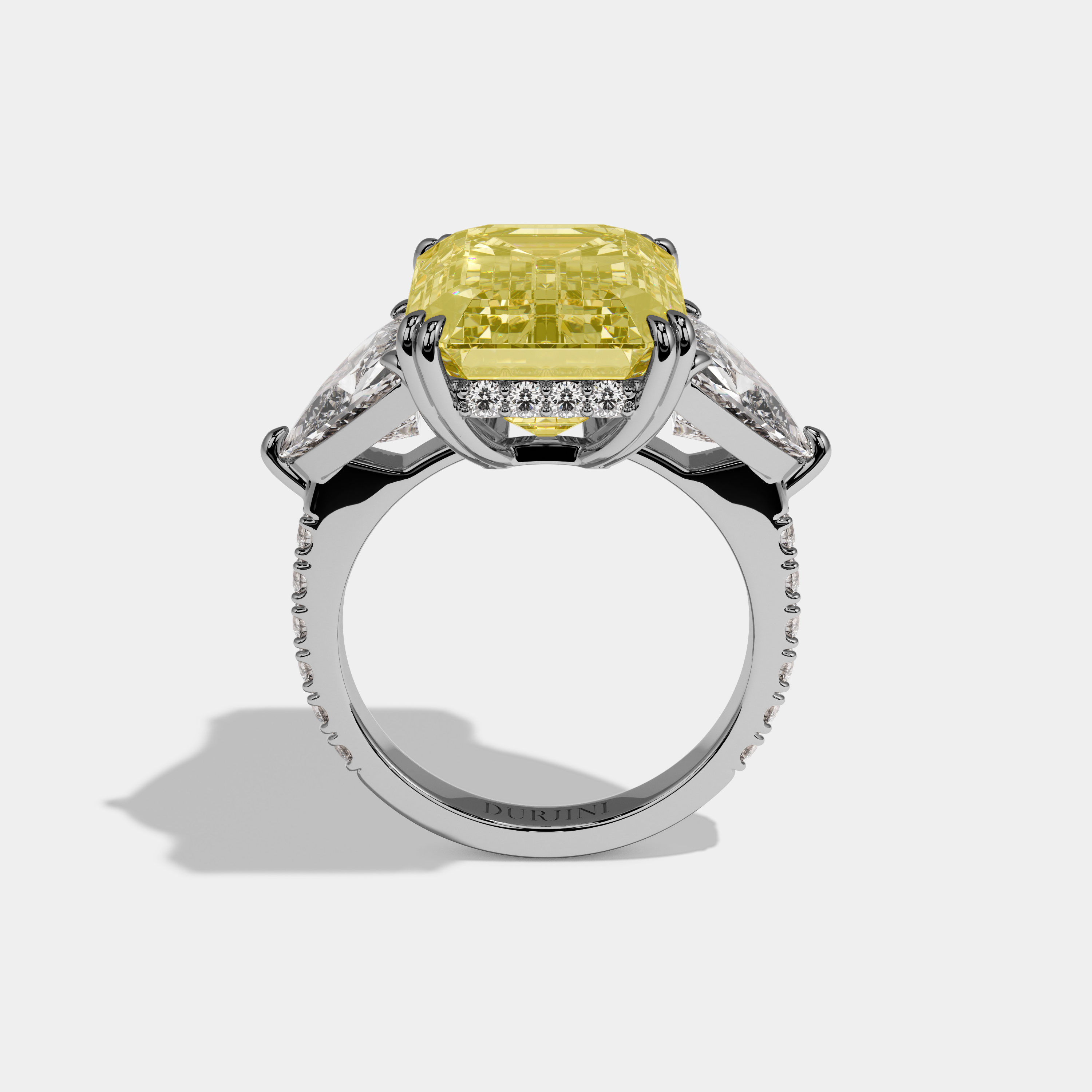 Vionnet Fancy Yellow Emerald Cut Diamond Halo Engagement Ring With Twin Trillion Cut Sides 10ct 18K White Gold