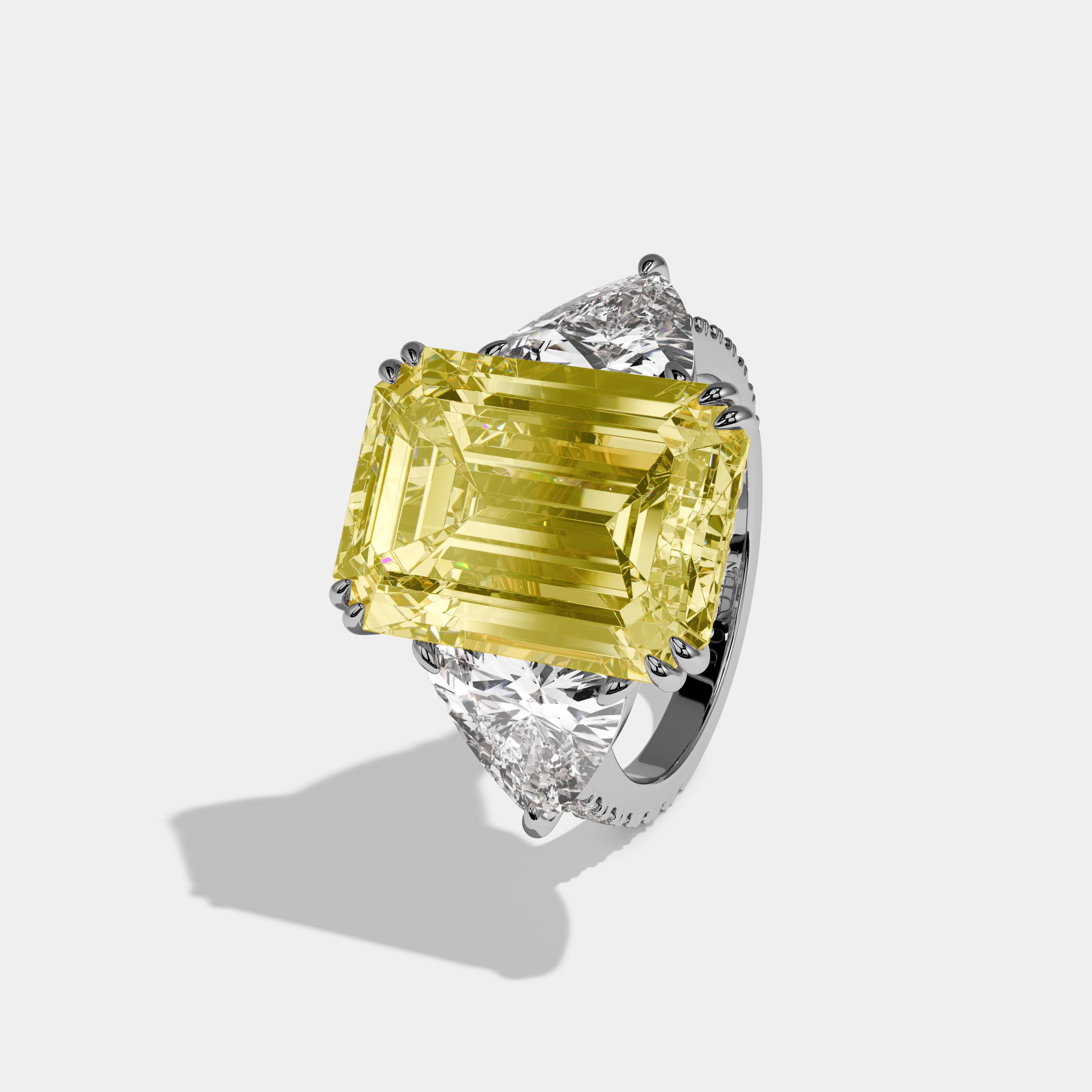 Vionnet Fancy Yellow Emerald Cut Diamond Halo Engagement Ring With Twin Trillion Cut Sides 10ct 18K White Gold