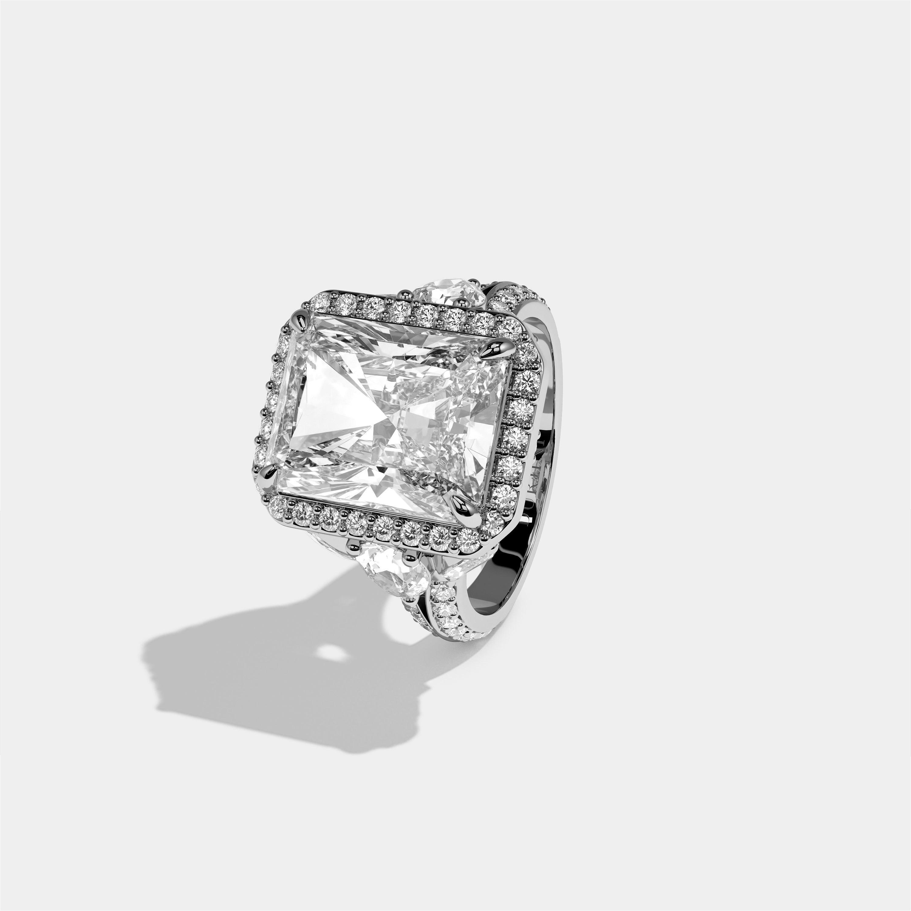 Rina Eclat diamond radiant halo engagement ring in 18K white gold by Kurbãni Durjini, left view