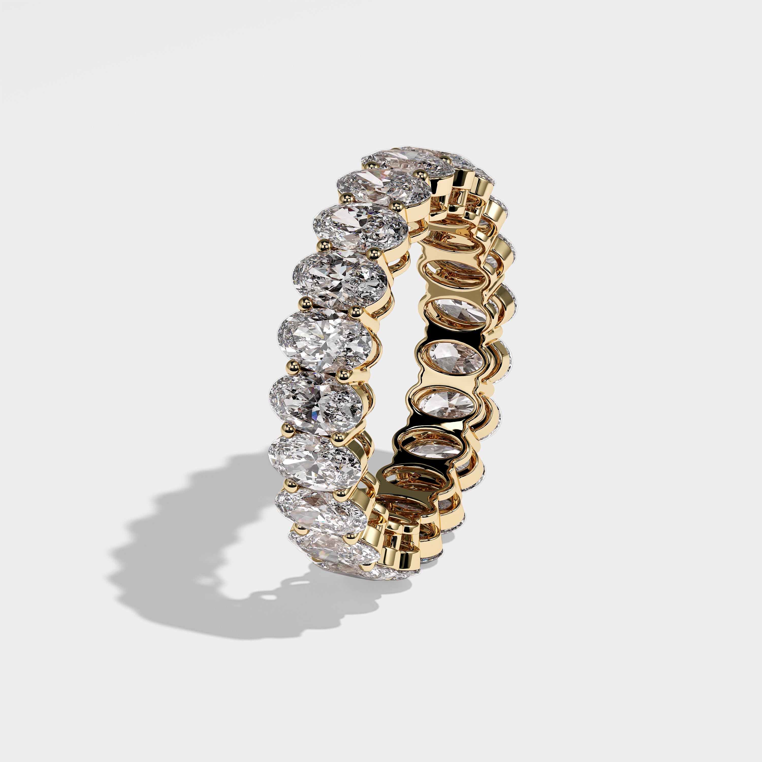 Emre oval-cut eternity diamond engagement ring in 18K yellow gold by Kurbãni Durjini, left side view