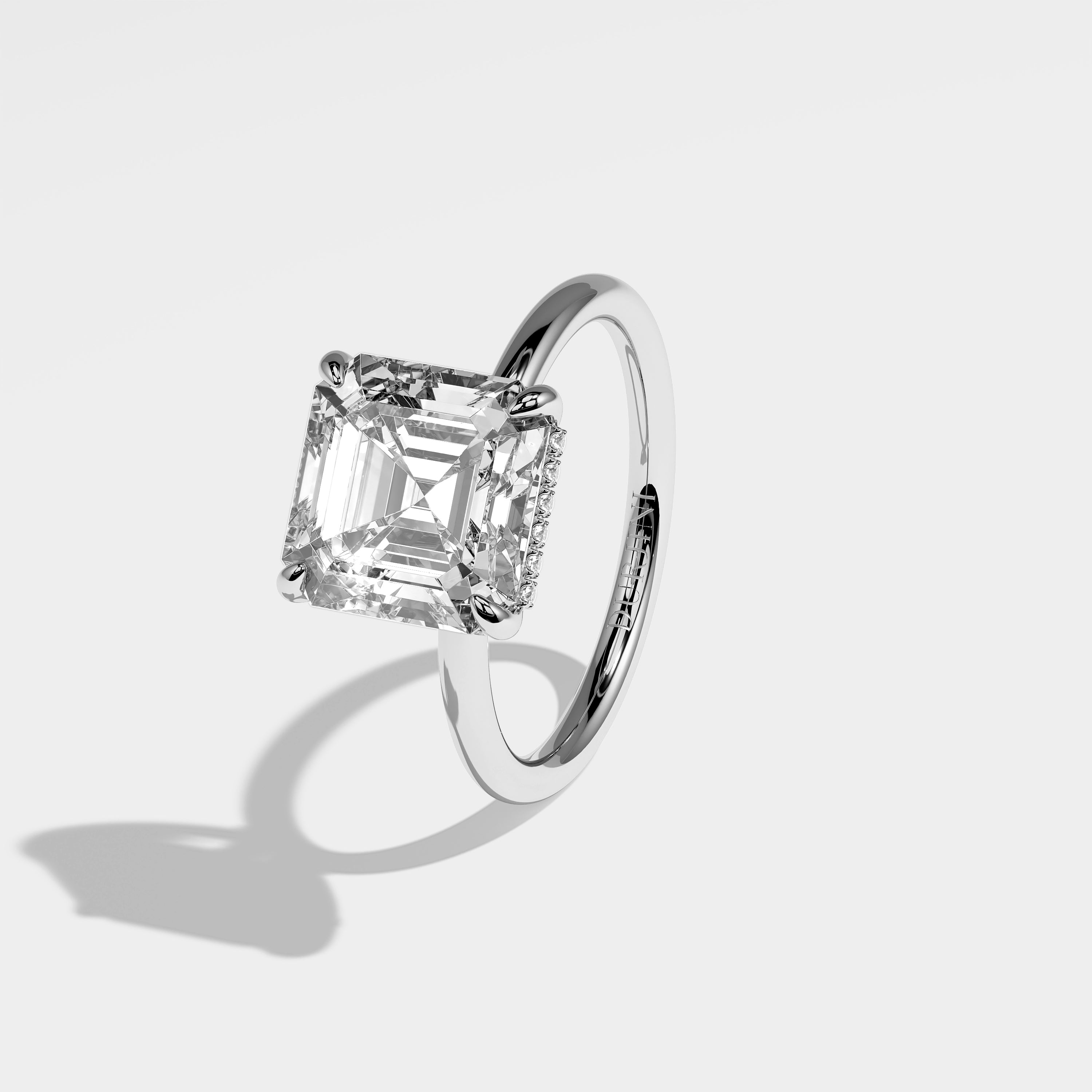 Leo Asscher-cut halo diamond engagement ring in 18K white gold by Kurbãni Durjini, left side view
