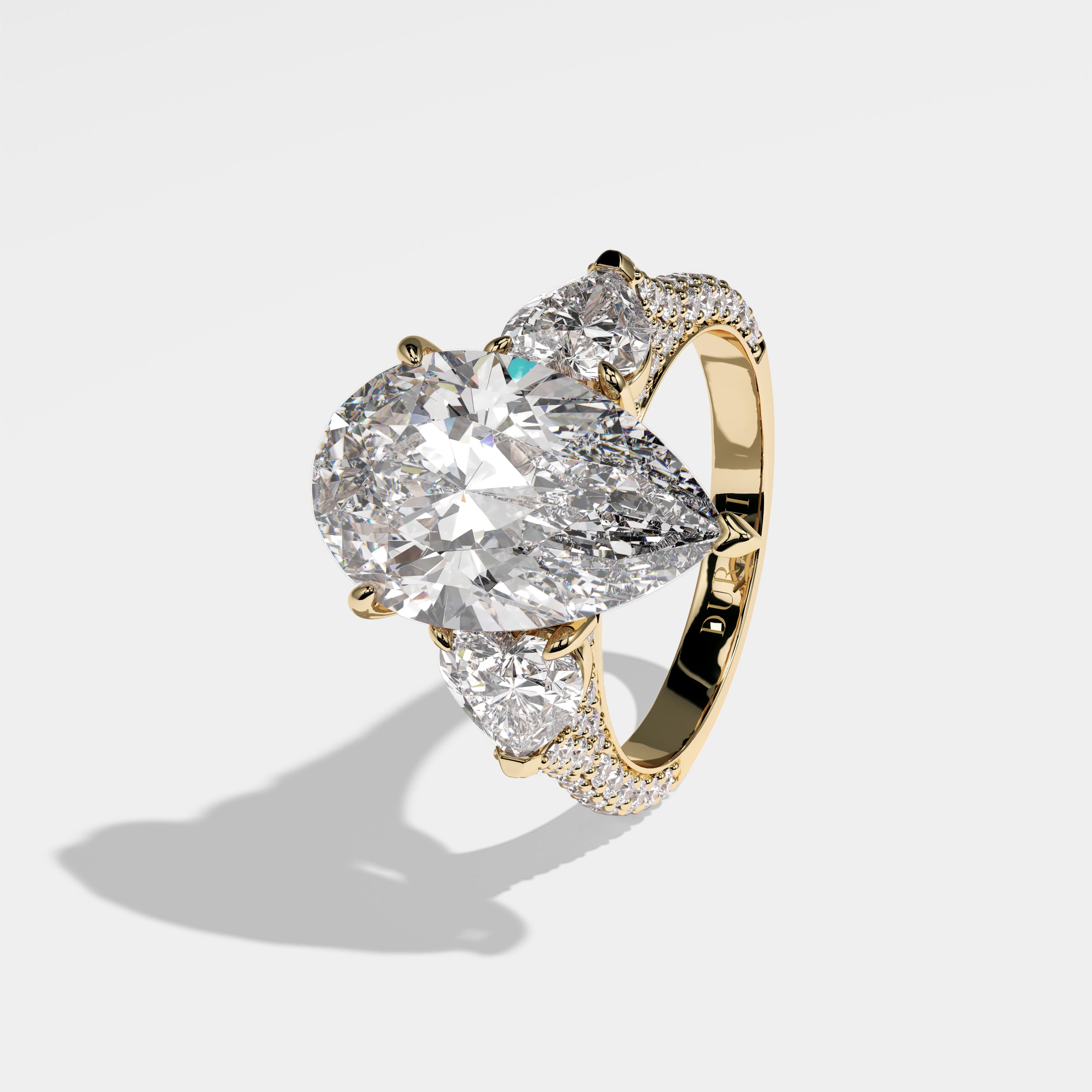 Sara pear-cut diamond engagement ring in 18K yellow gold by Kurbãni Durjini, left side view