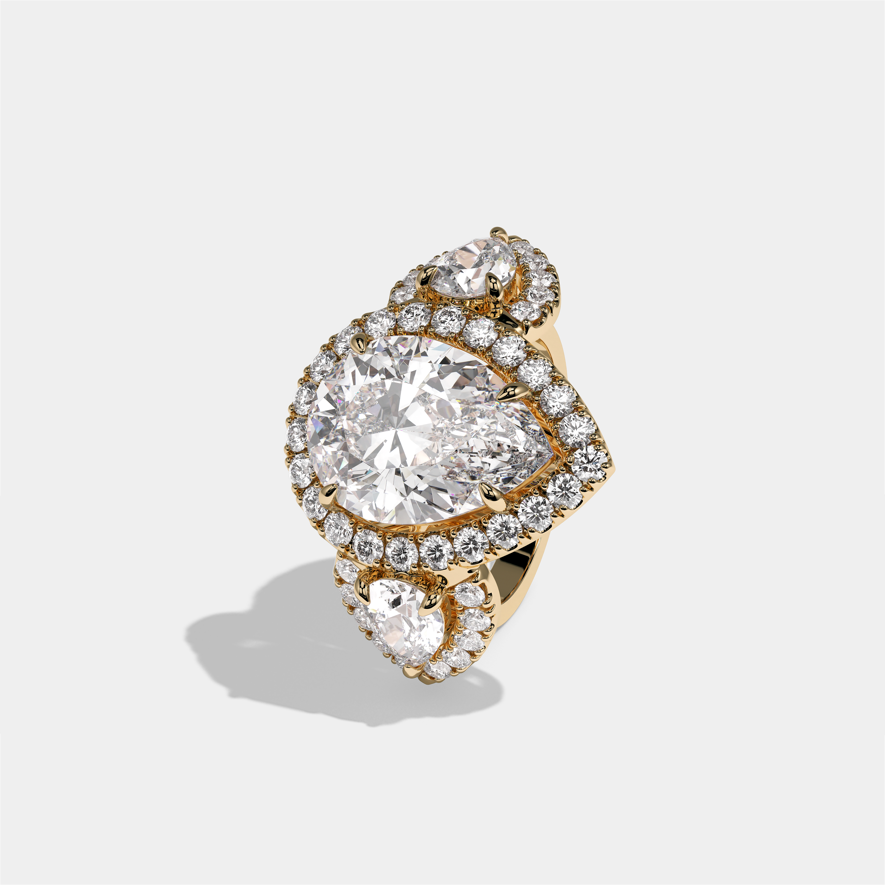 Dorothea Duchess diamond pear halo engagement ring in 18K yellow gold by Kurbãni Durjini, left view