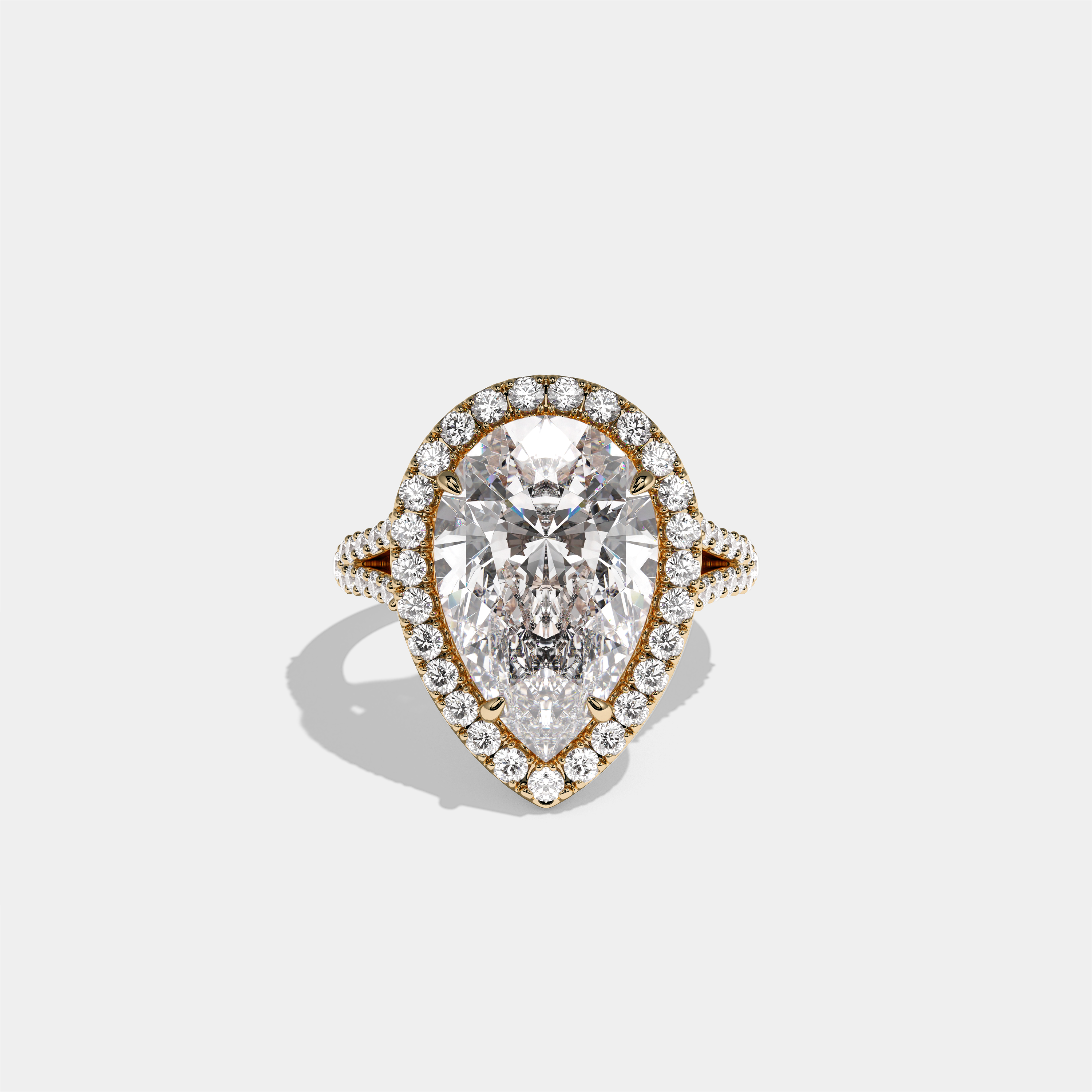 Helena Viscountess diamond pear halo engagement ring in 18K yellow gold by Kurbãni Durjini, front view