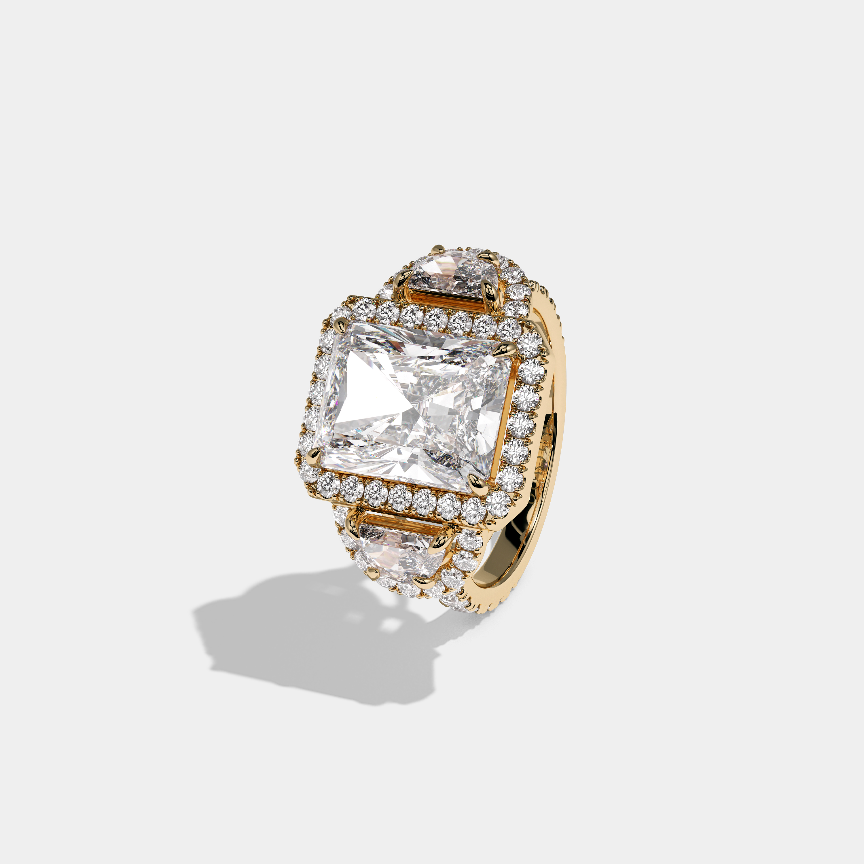 Aveline Lady Godiva diamond radiant halo engagement ring in 18K yellow gold by Kurbãni Durjini, left view