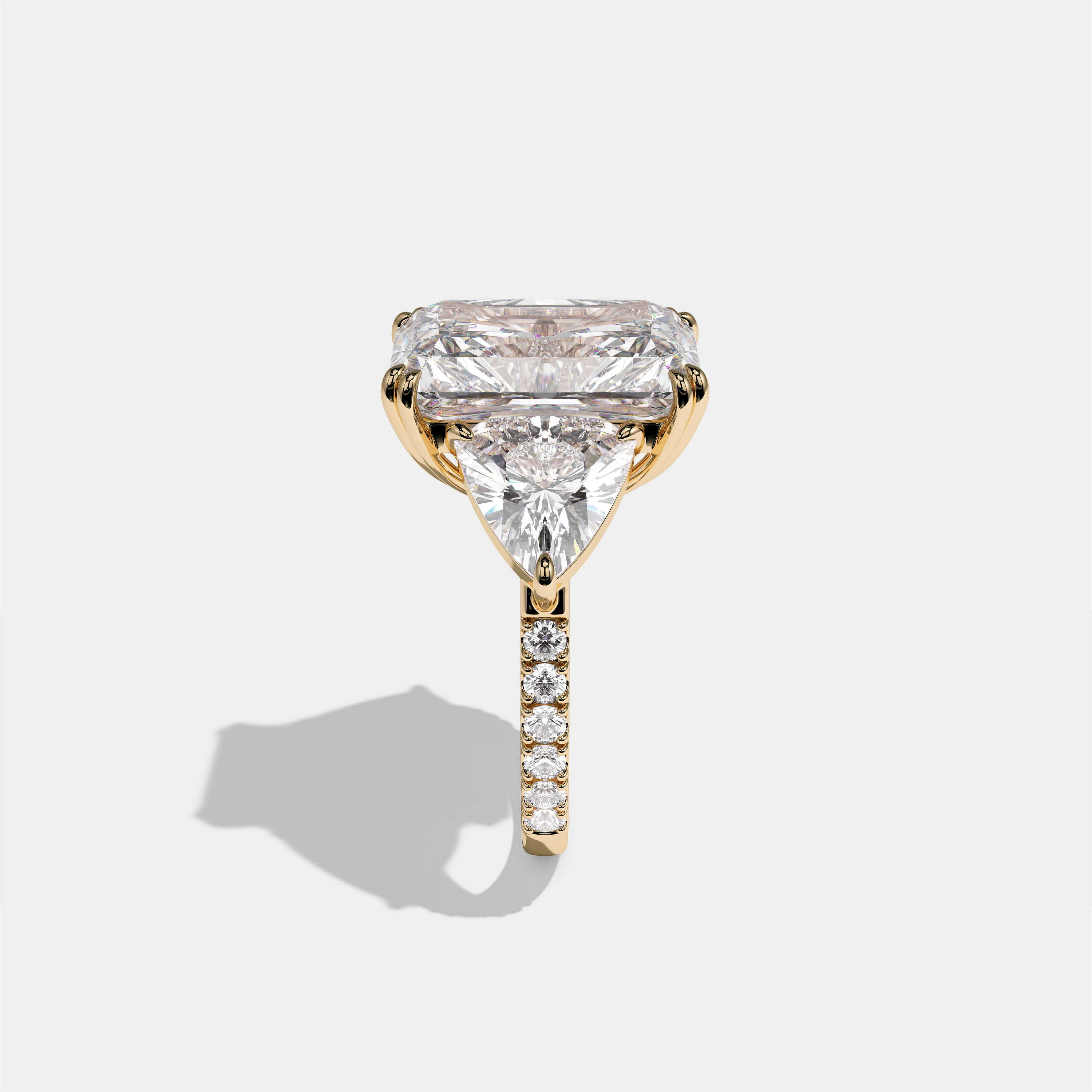 Tzipporah Lady Highbourne diamond radiant halo engagement ring in 18K yellow gold by Kurbãni Durjini, side view