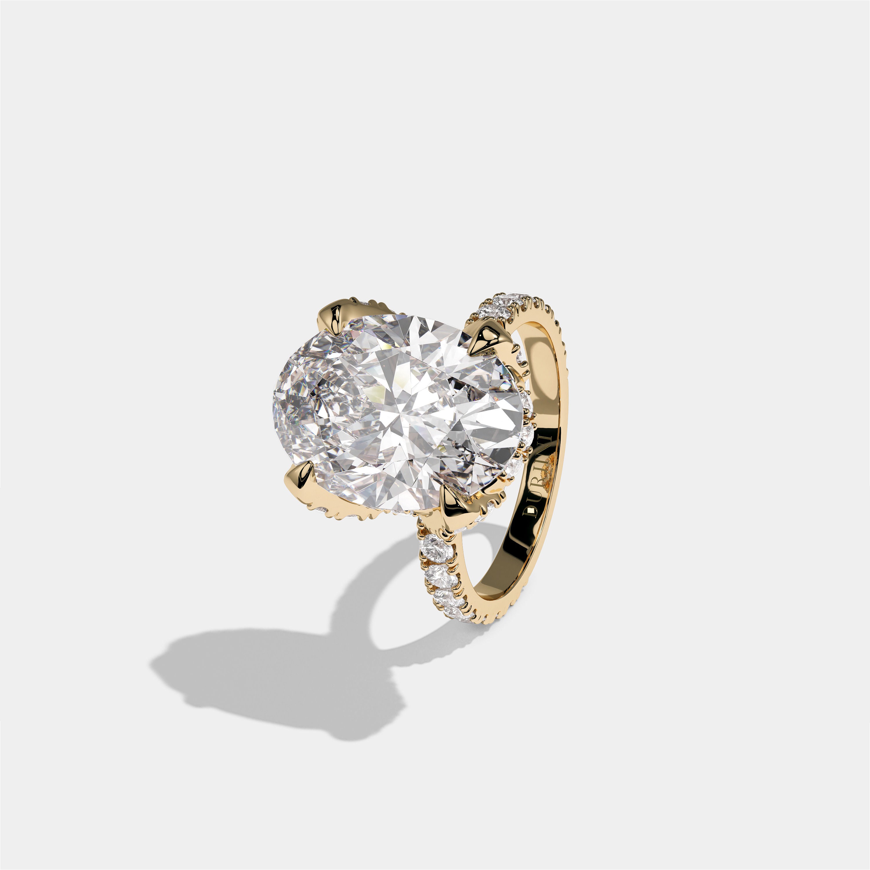 Rebecca Lady Ainsworth diamond oval halo engagement ring in 18K yellow gold by Kurbãni Durjini, left view