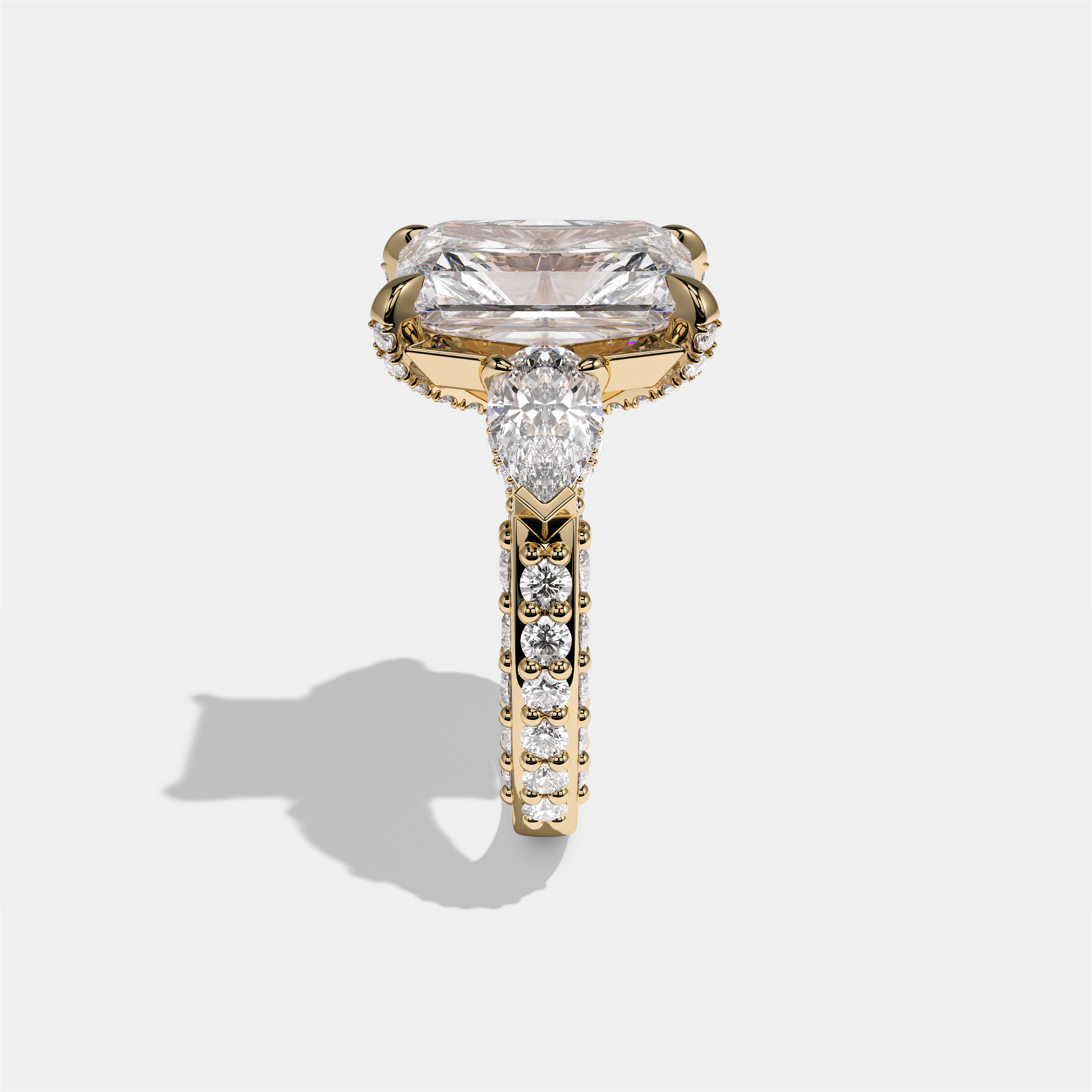 Hannah Eclat Kingsbridge diamond radiant halo engagement ring in 18K yellow gold by Kurbãni Durjini, side view