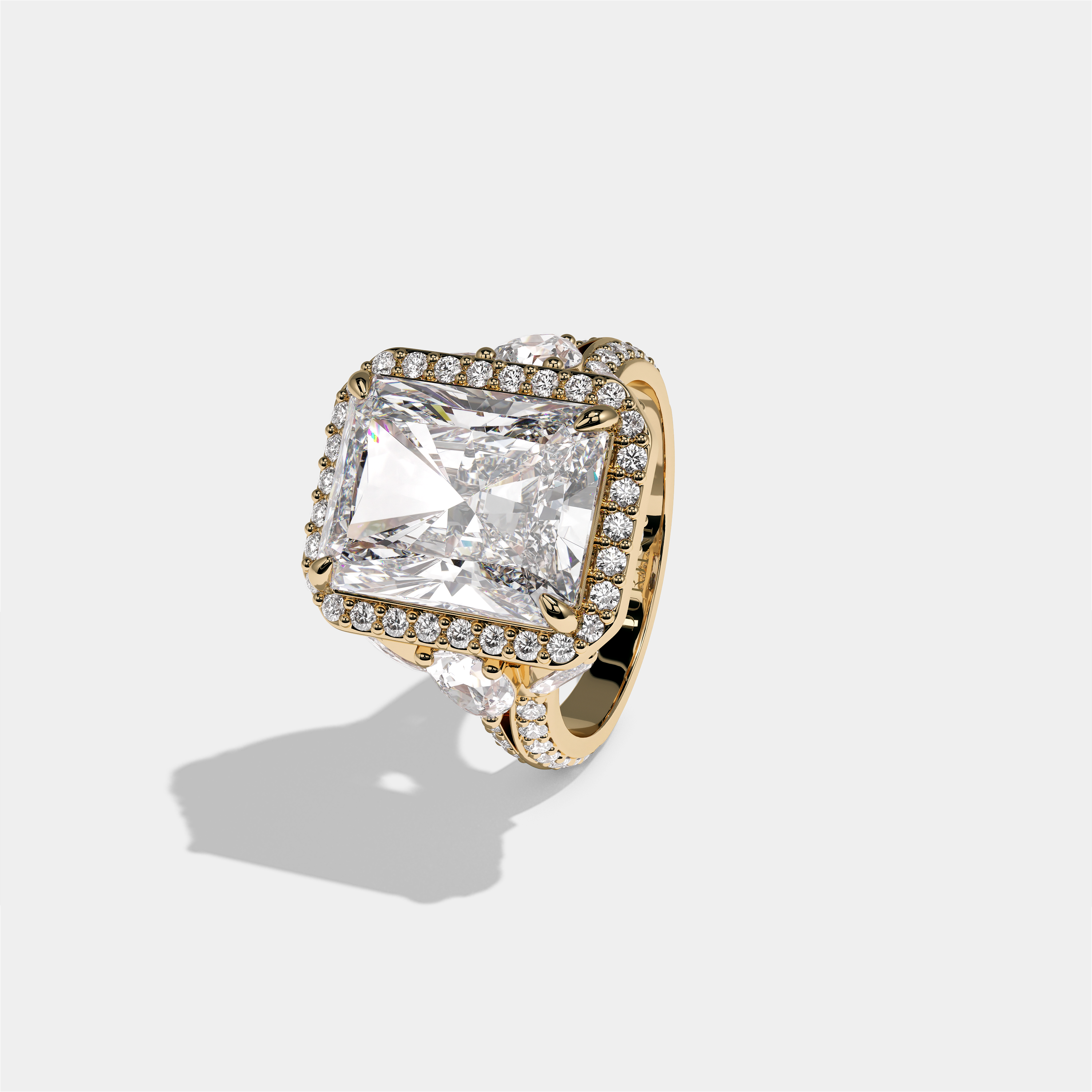 Rina Eclat Ashbourne diamond radiant halo engagement ring in 18K yellow gold by Kurbãni Durjini, left view