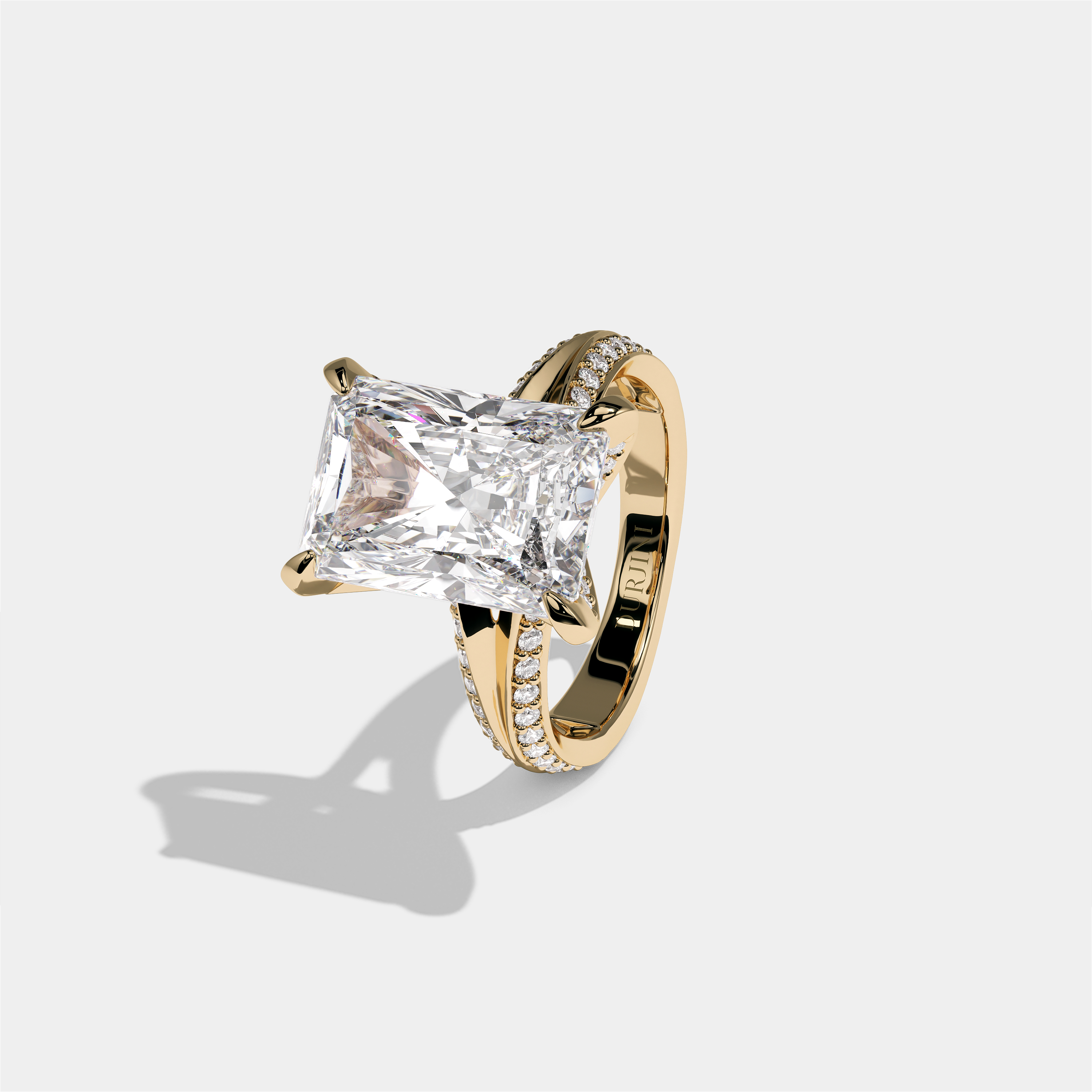 Gila Eclat Highbury diamond radiant halo engagement ring in 18K yellow gold by Kurbãni Durjini, left view