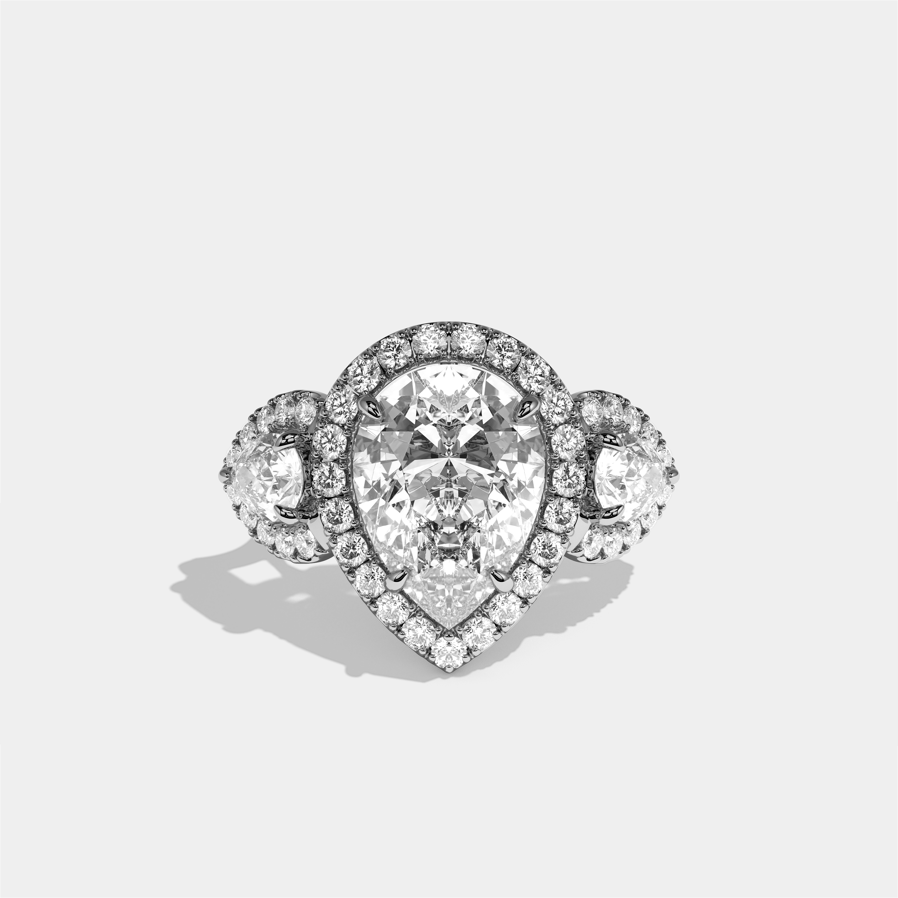 Dorothea Élégance diamond pear halo engagement ring in 18K white gold by Kurbãni Durjini, front view