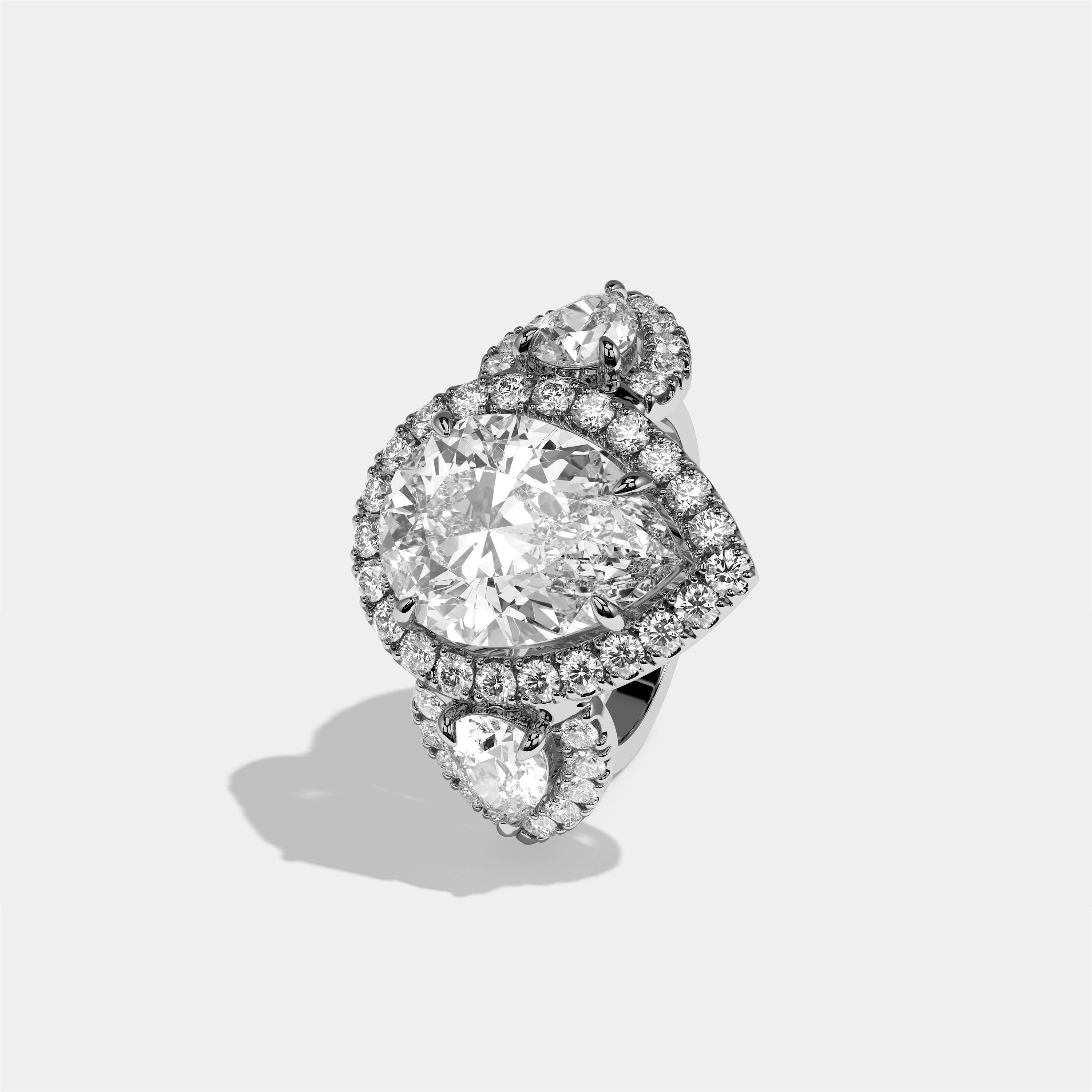 Dorothea Élégance diamond pear halo engagement ring in 18K white gold by Kurbãni Durjini, left view