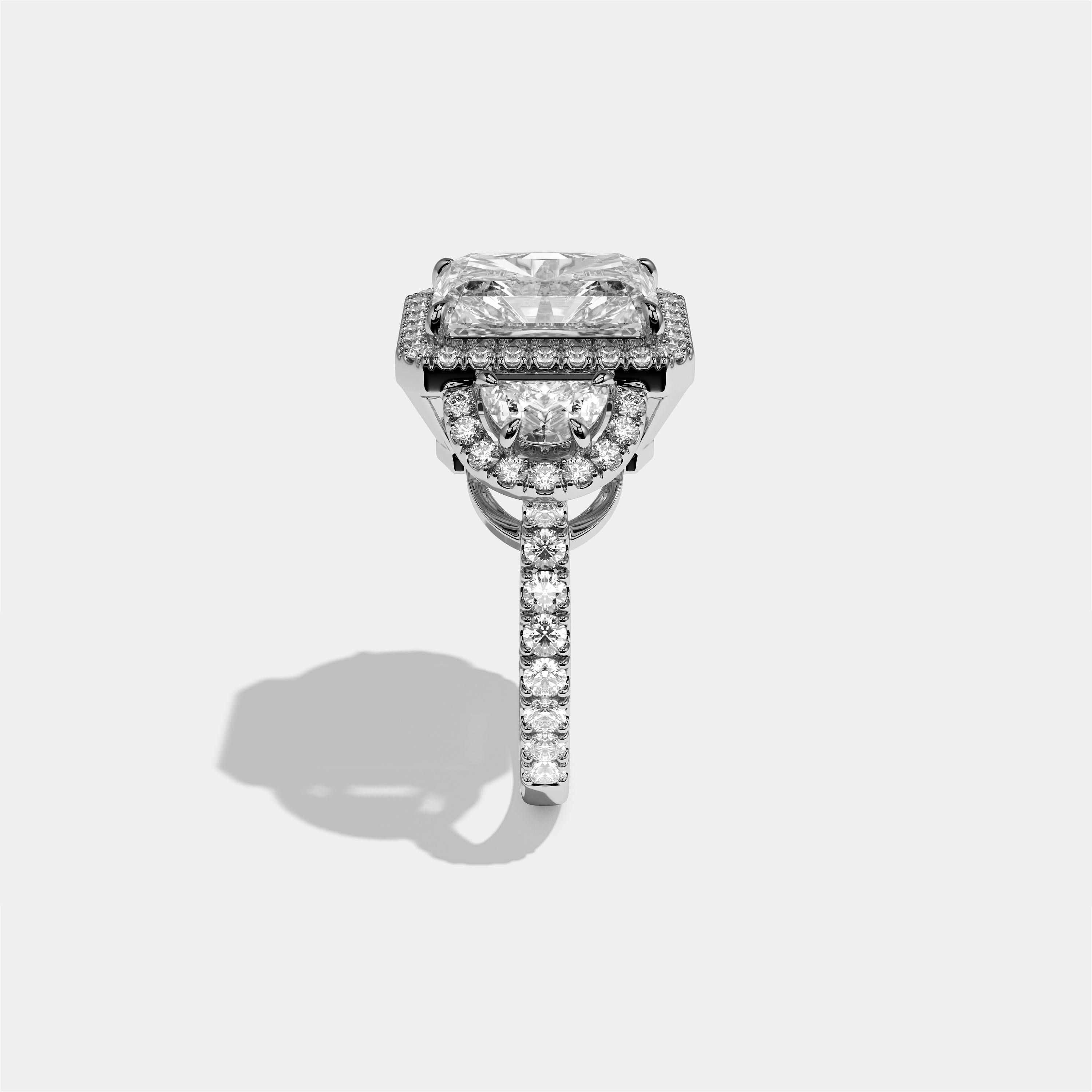 Aveline Godiva diamond radiant halo engagement ring in 18K white gold by Kurbãni Durjini, side view