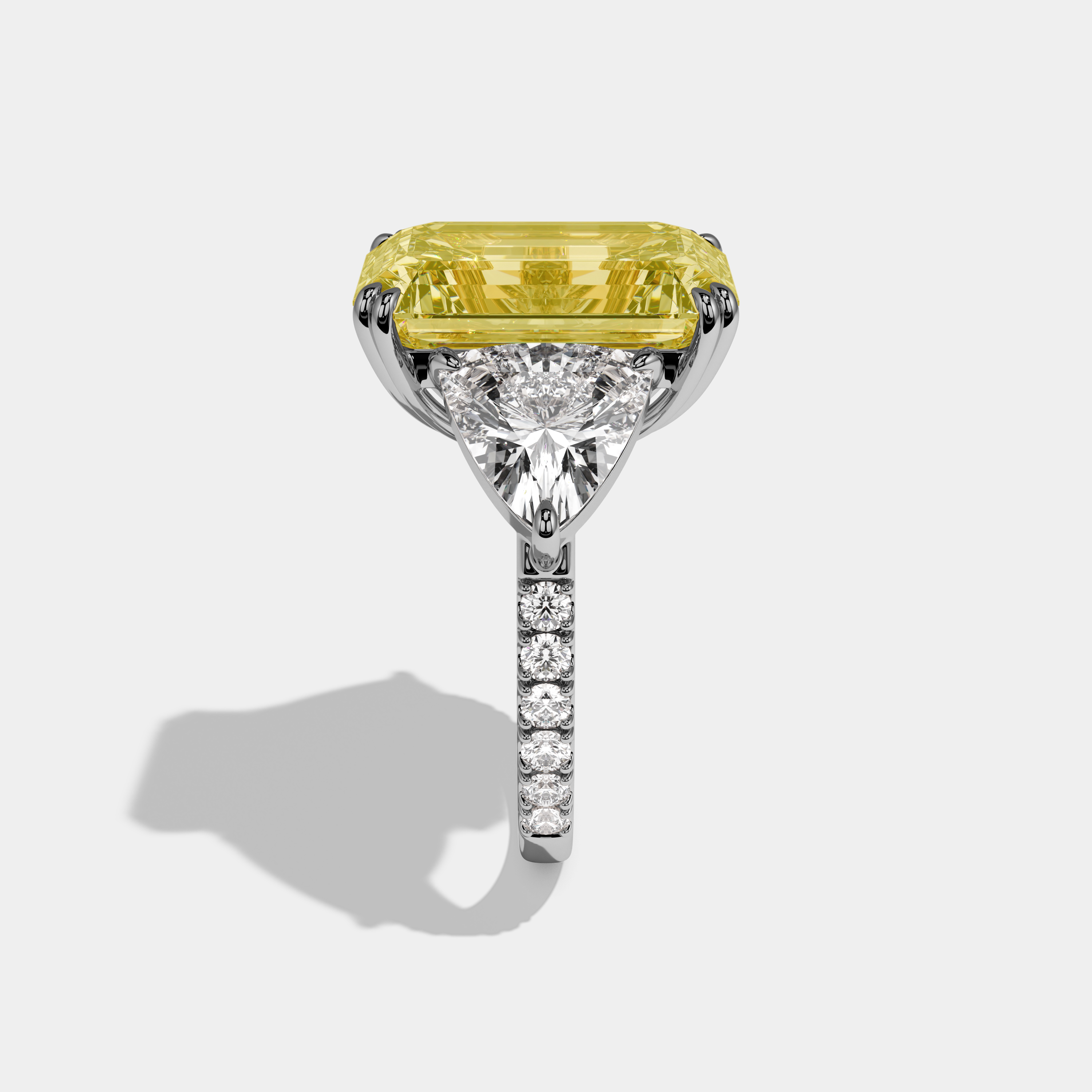 Vionnet Fancy Yellow Emerald Cut Diamond Halo Engagement Ring With Twin Trillion Cut Sides 10ct 18K White Gold